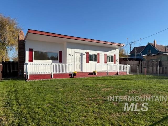 Fenced front yard with nice deck