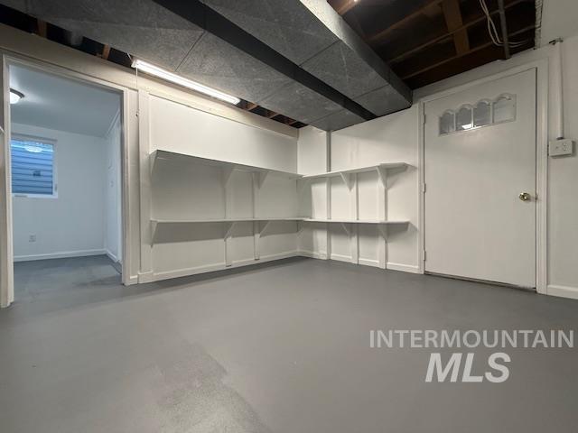 Unfinished basement featuring baseboards