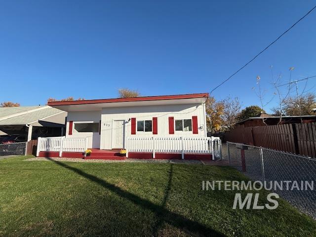 View of front of house featuring a wooden deck