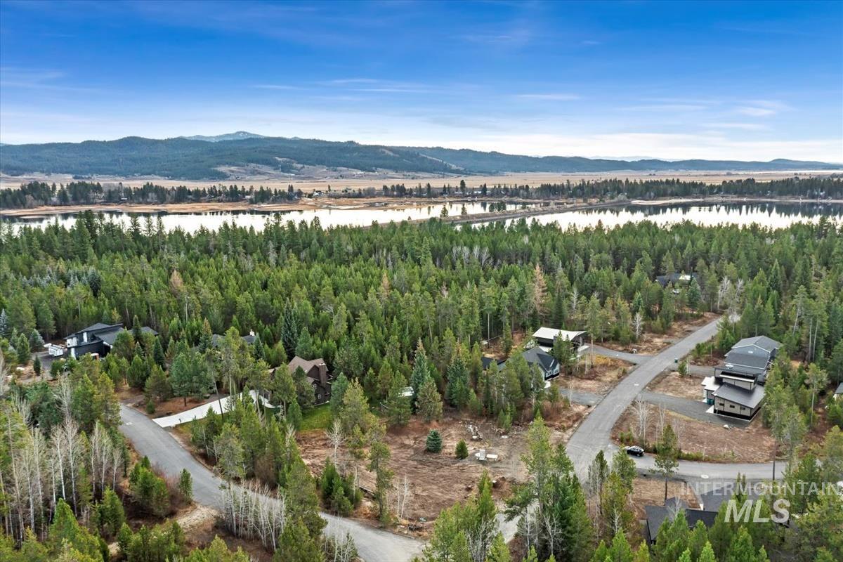 Drone / aerial view of a water and mountain view and a heavily wooded area