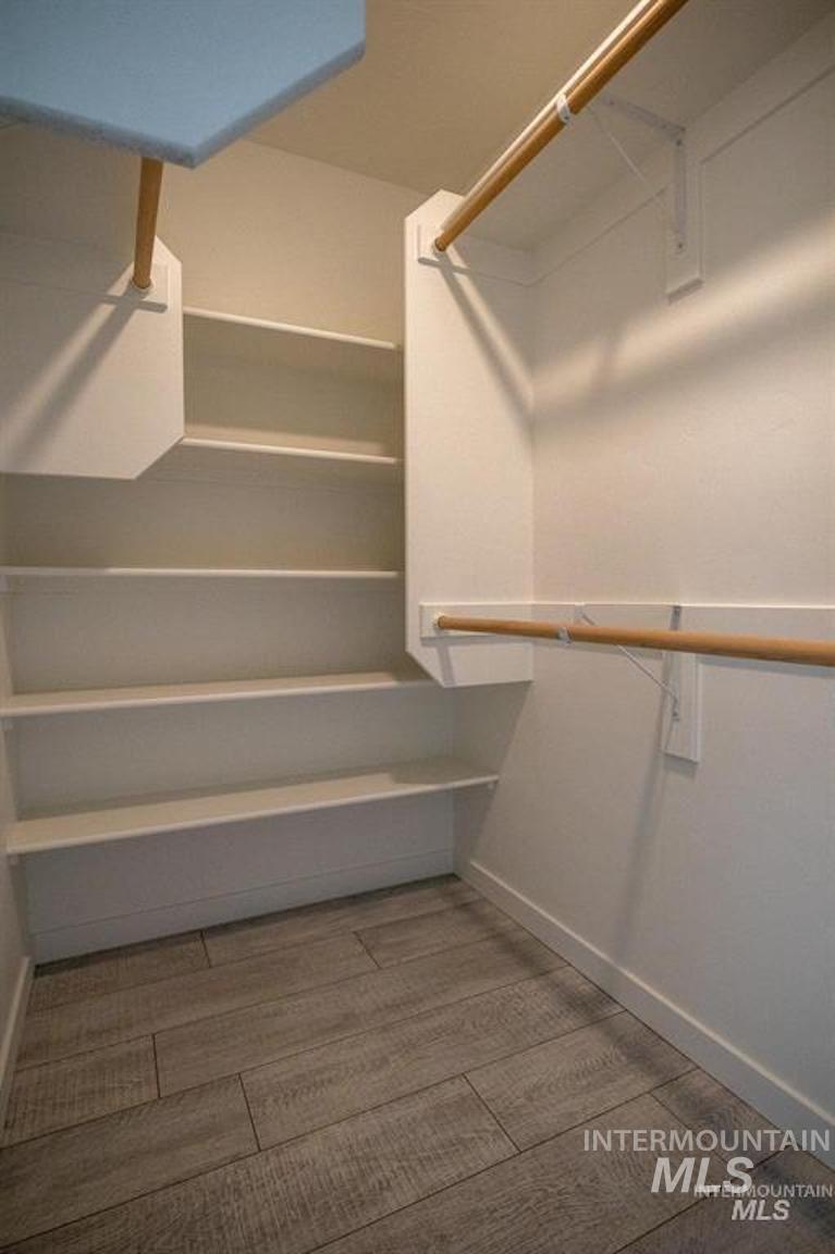 Walk in closet featuring light wood-type flooring