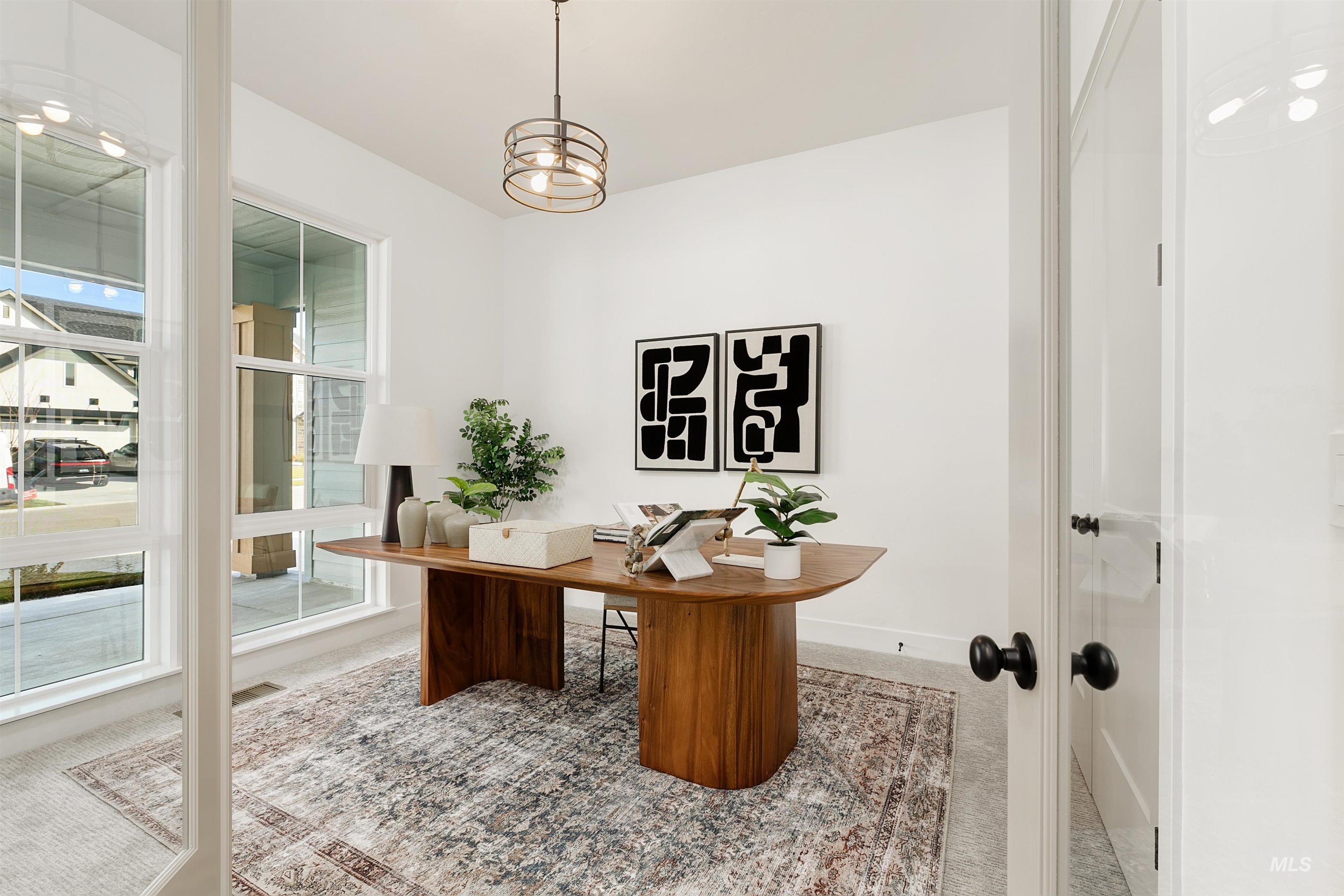 Carpeted home office featuring baseboards