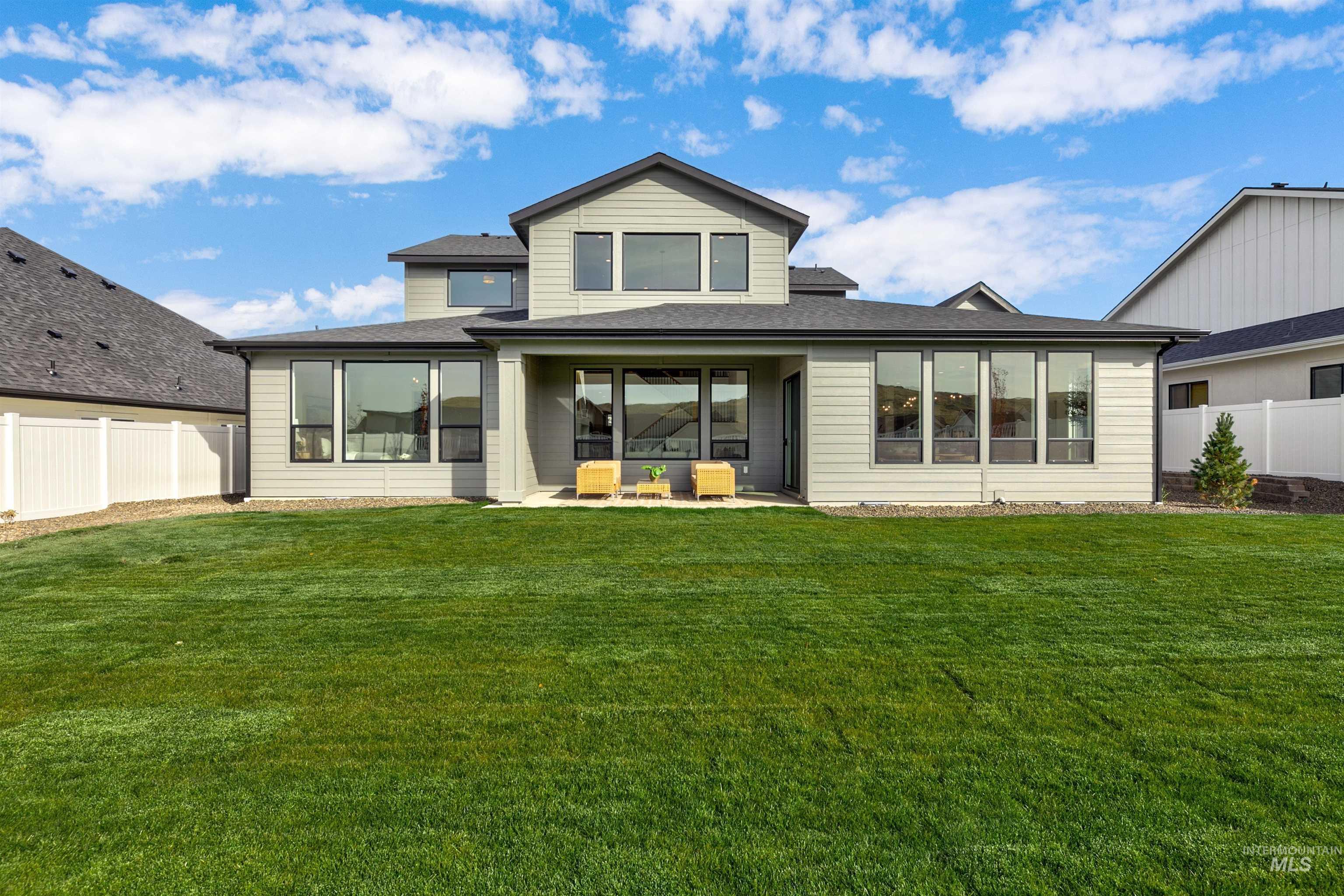 Back of house with a fenced backyard, a patio, and a shingled roof