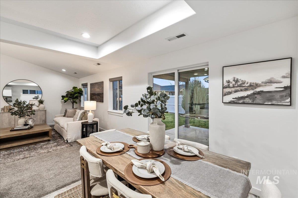 Dining room with lofted ceiling and recessed lighting