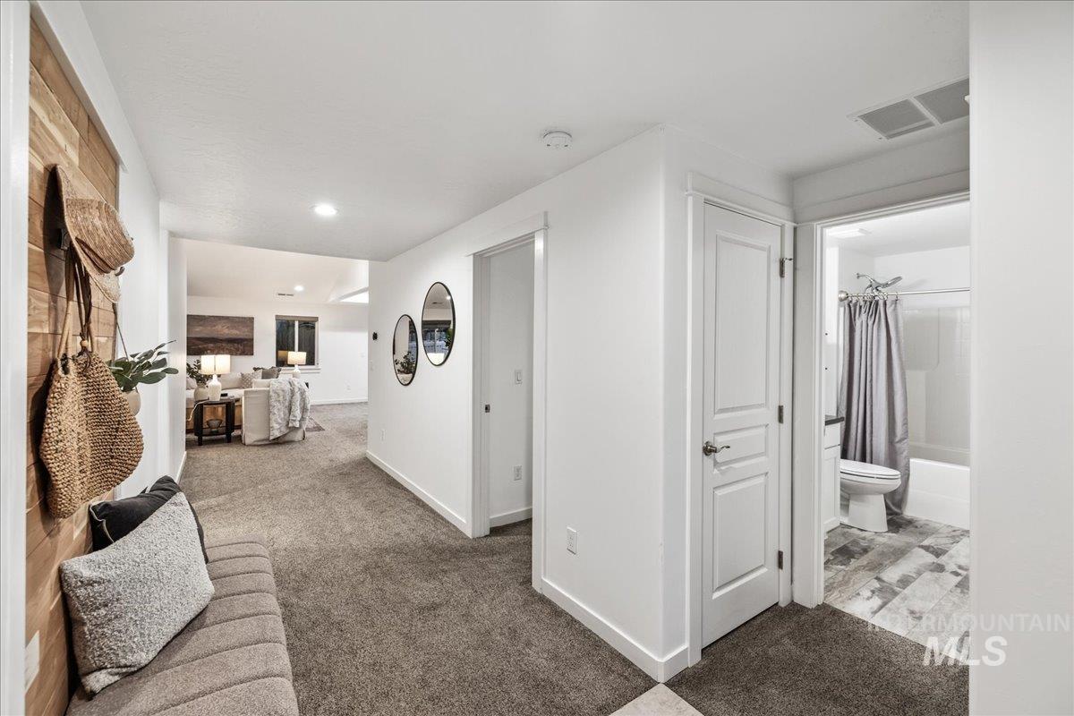 Corridor with light carpet and recessed lighting