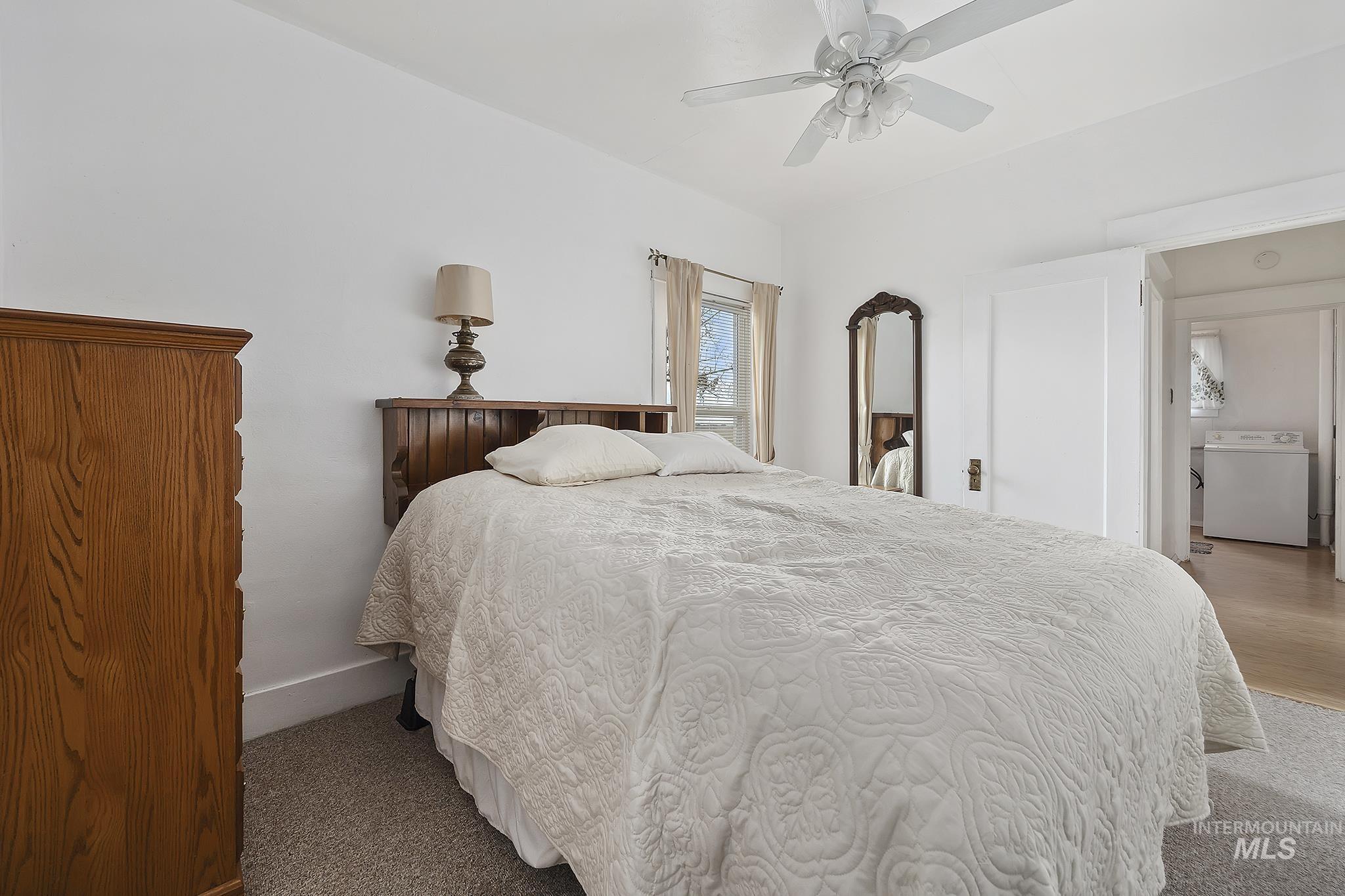 Bedroom featuring washer / dryer and a ceiling fan