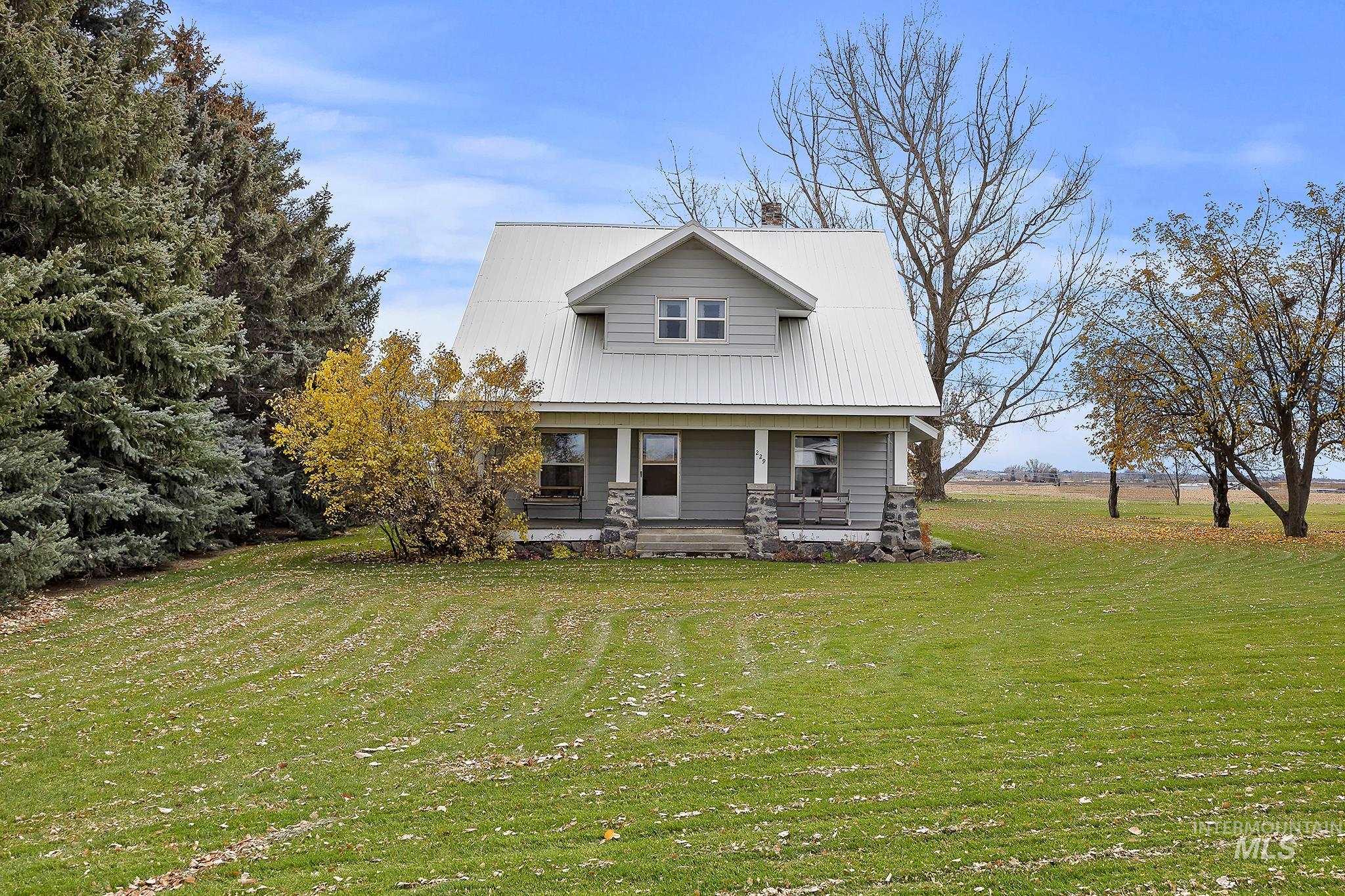 View of front of property with a front lawn and a porch