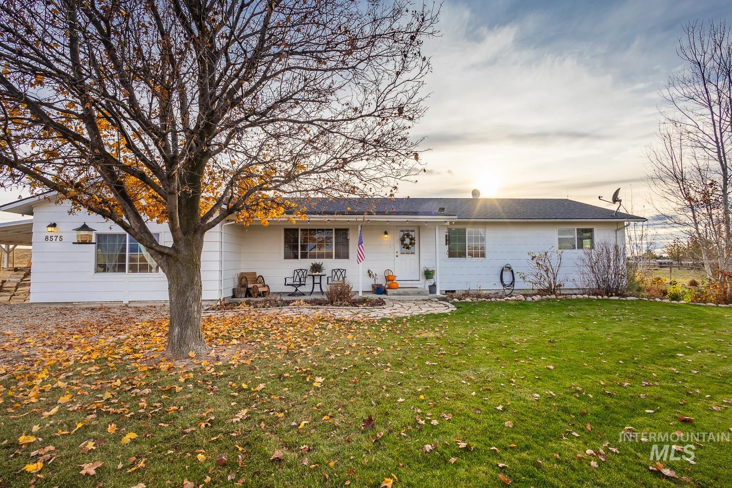 Rear view of property featuring a porch and a lawn