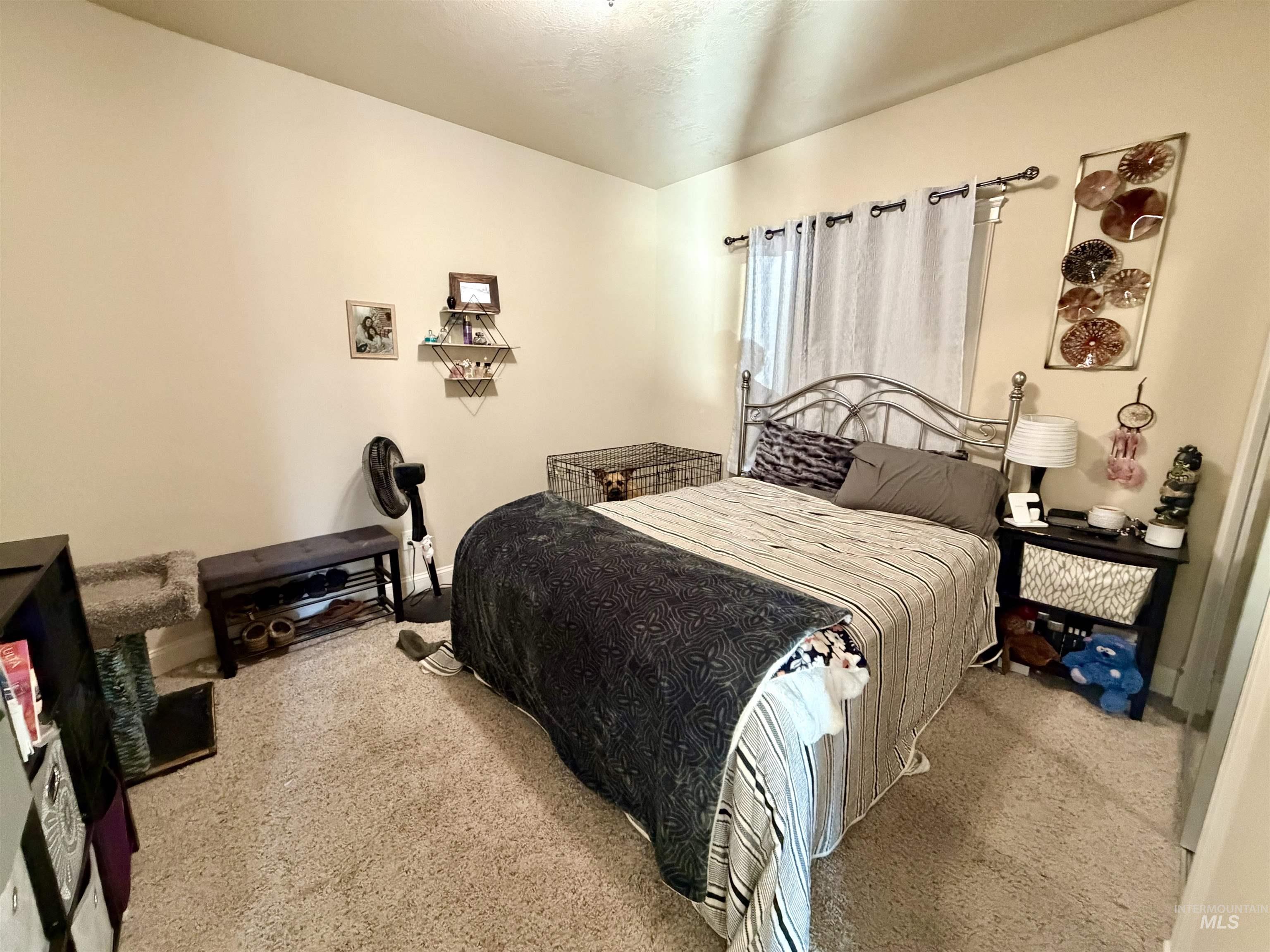 Bedroom featuring light carpet