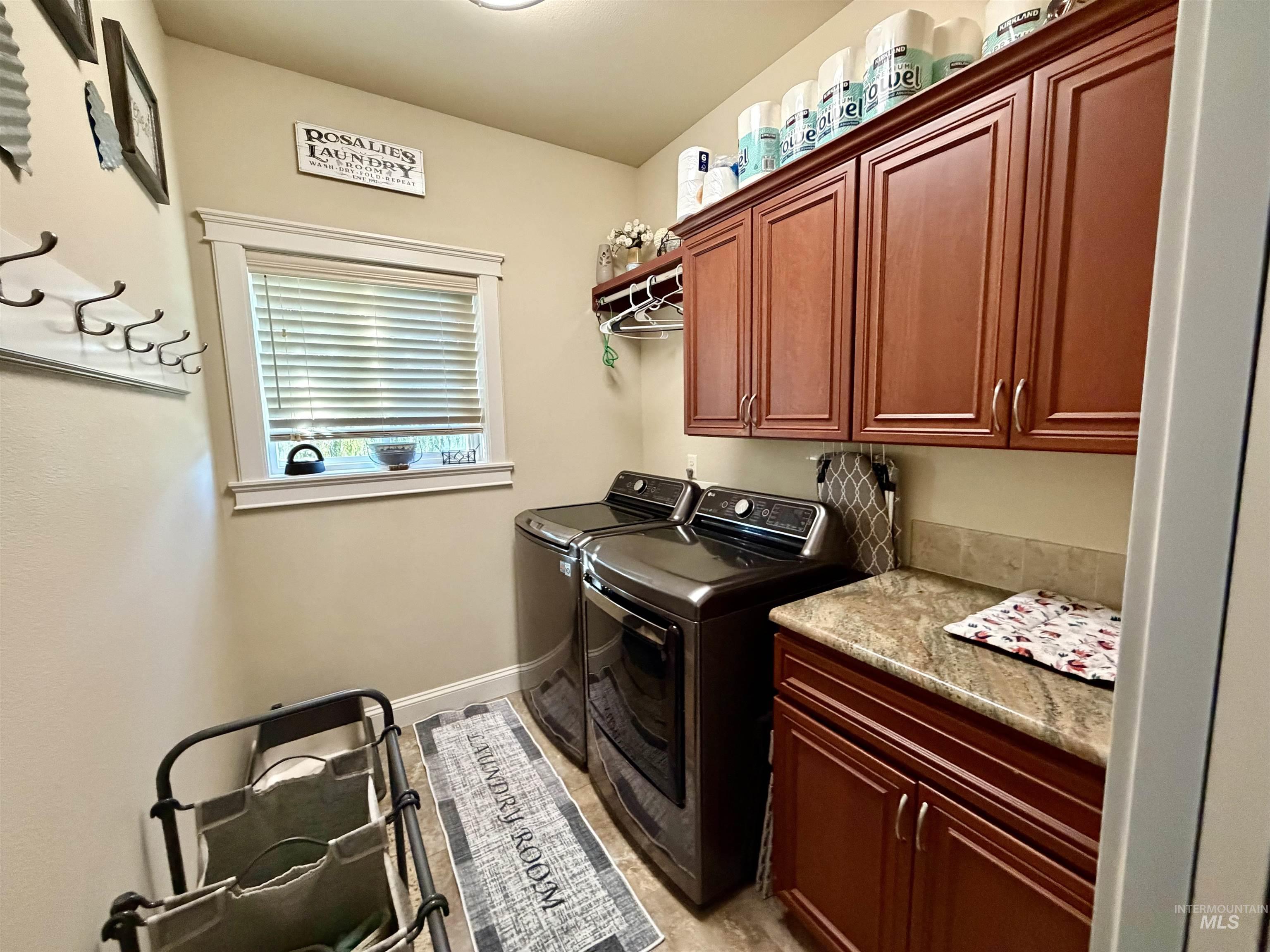 Laundry room featuring cabinet space and separate washer and dryer