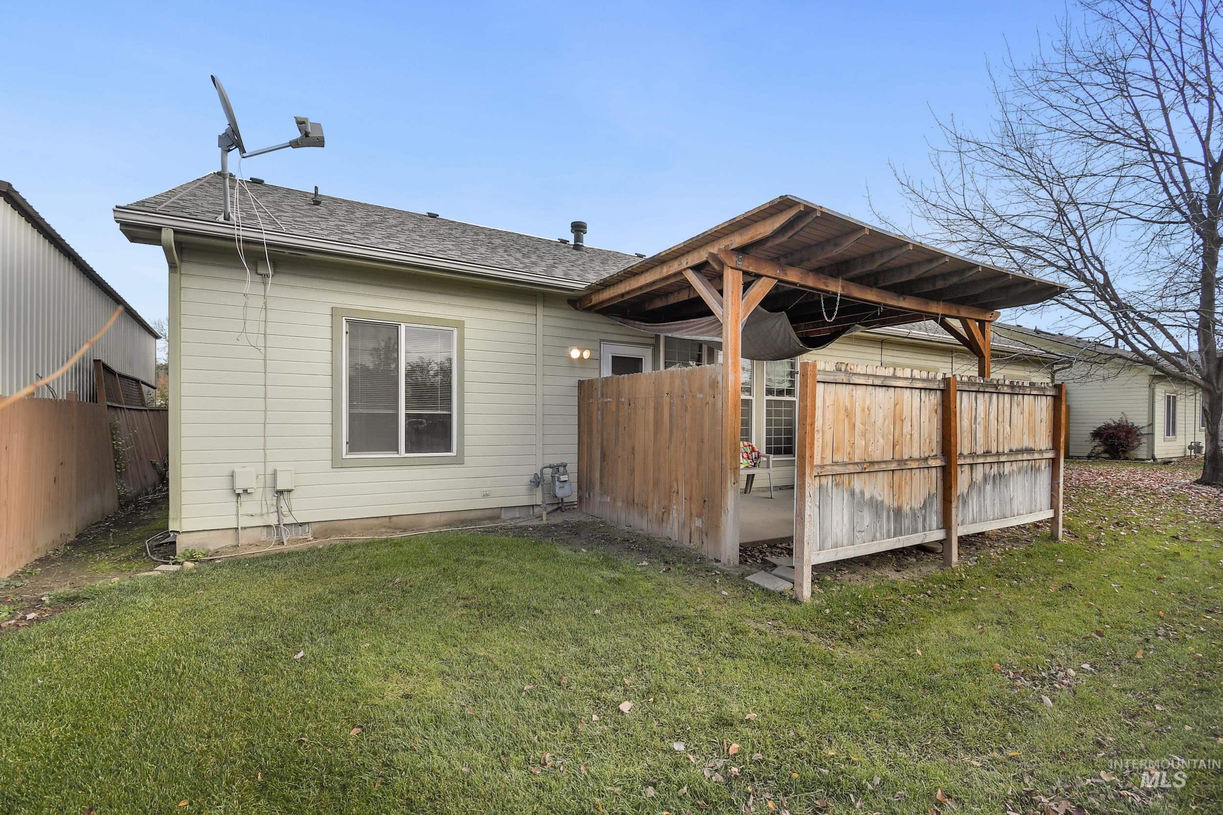 Rear view of property with roof with shingles