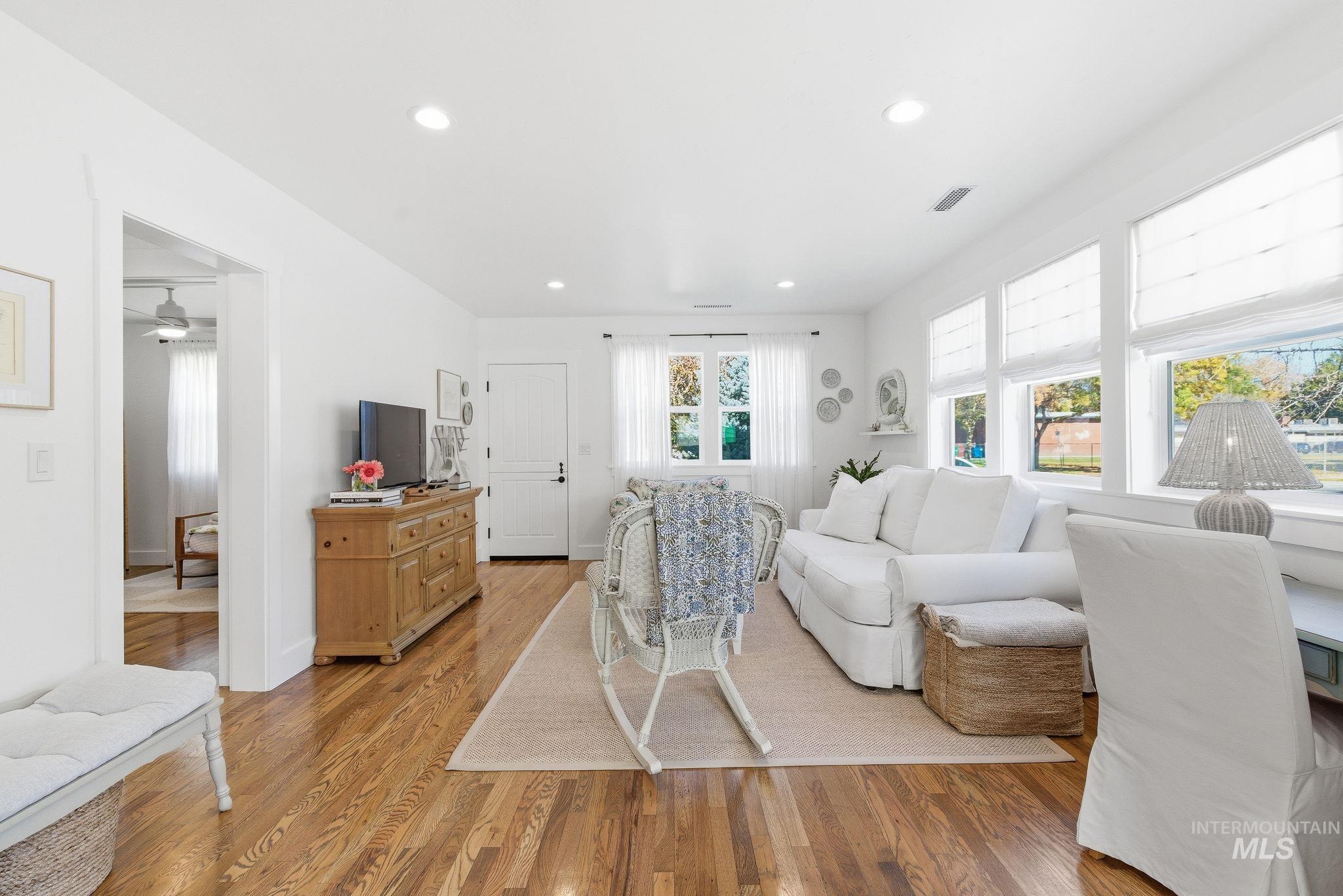 Living area featuring light wood finished floors and recessed lighting