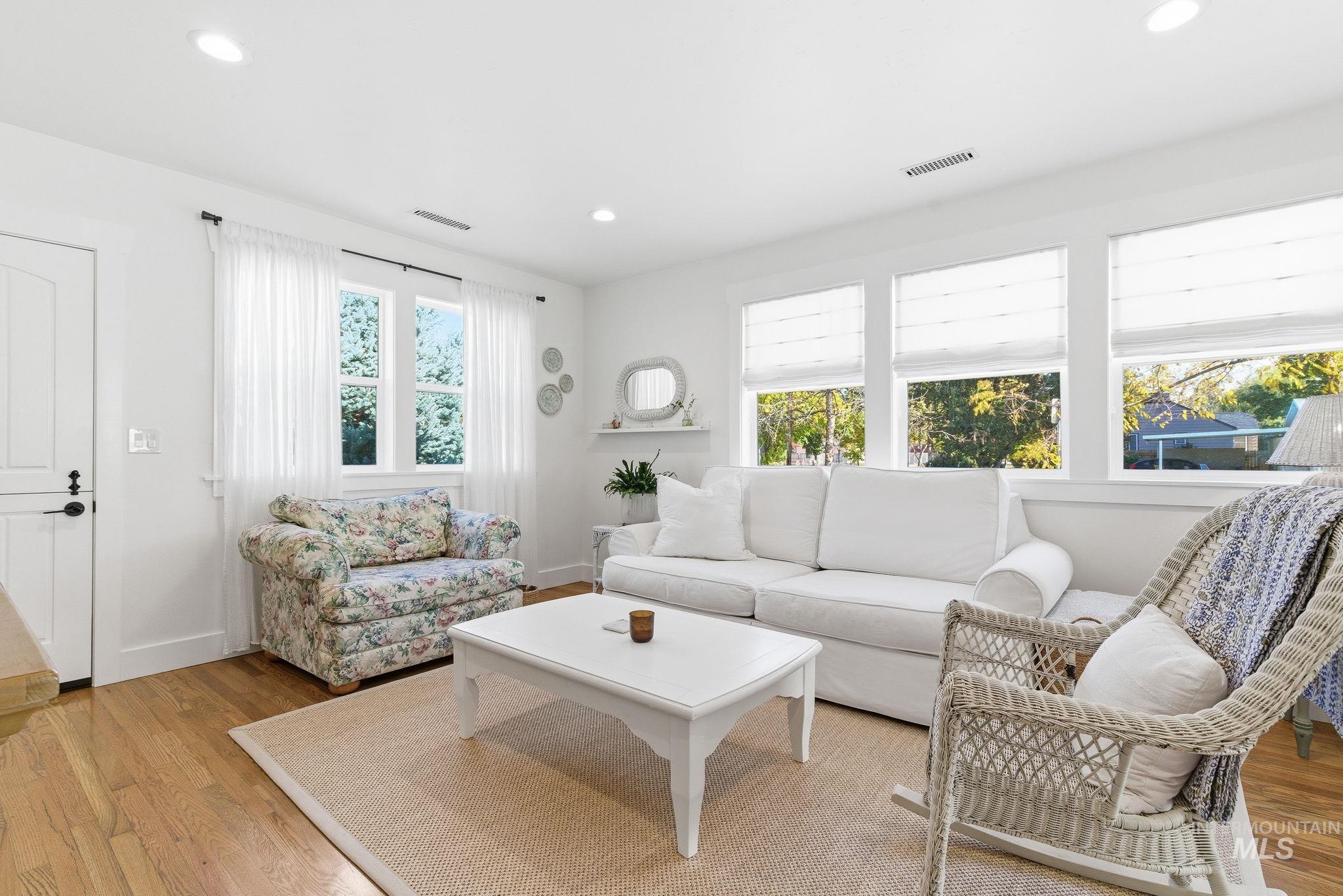Living room with light wood-style floors and recessed lighting