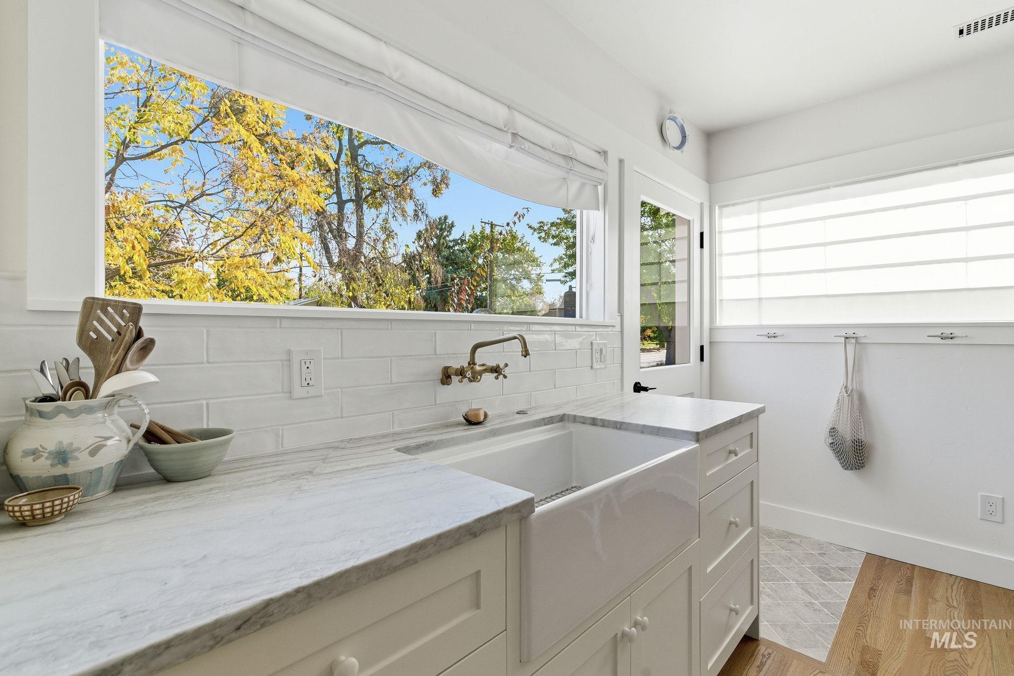 Washroom featuring light wood-type flooring and a sink