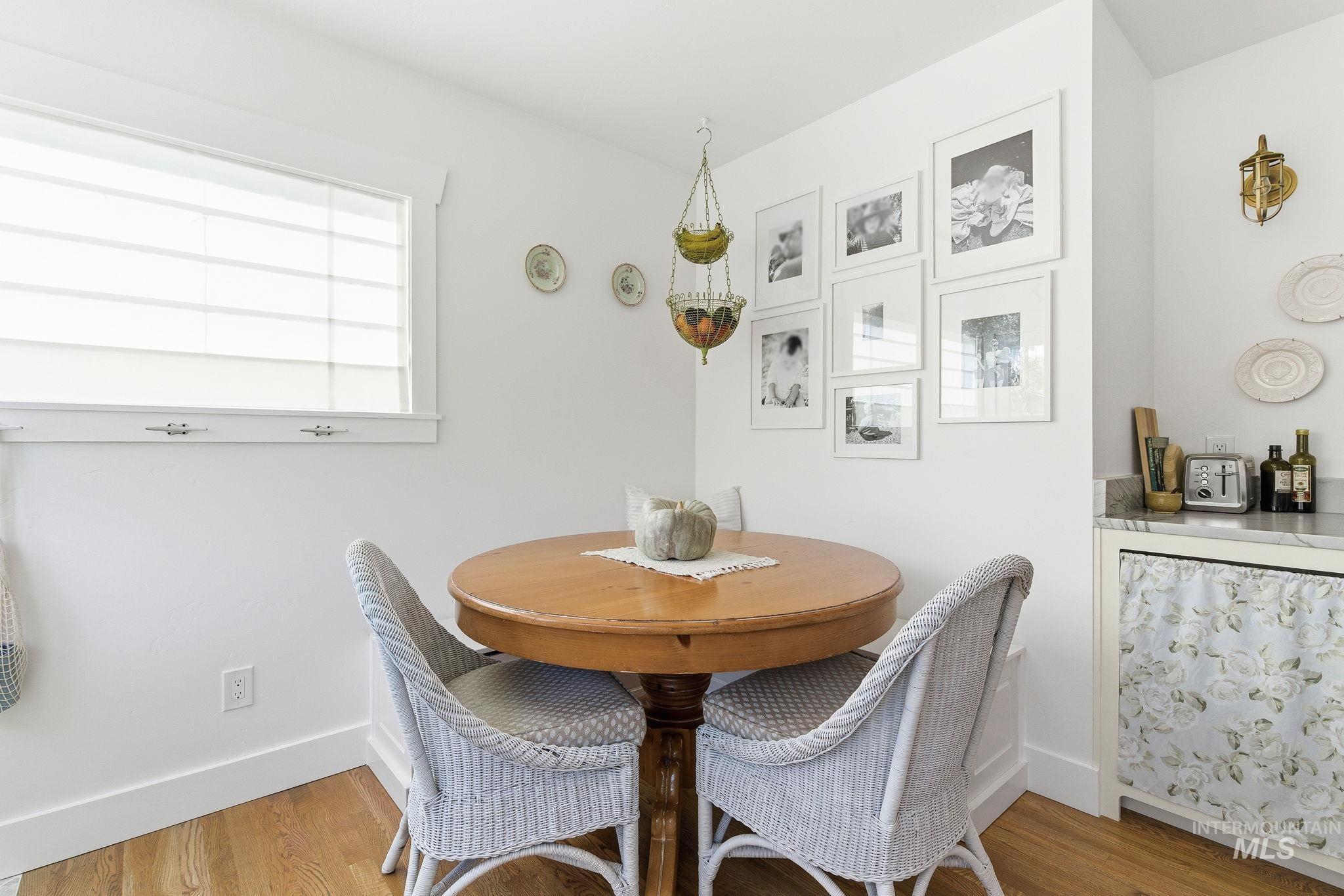 Dining space with baseboards and light wood-style flooring