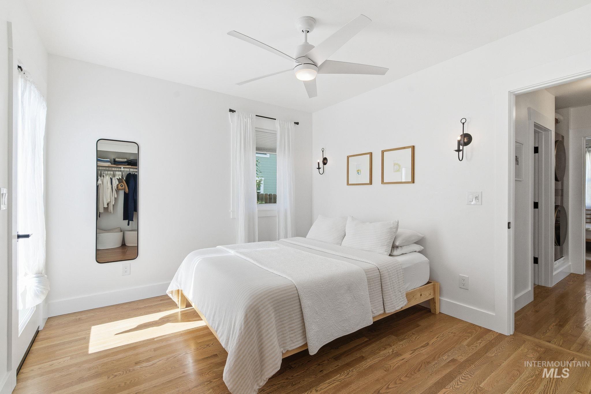 Bedroom featuring light wood-style flooring, a closet, and ceiling fan