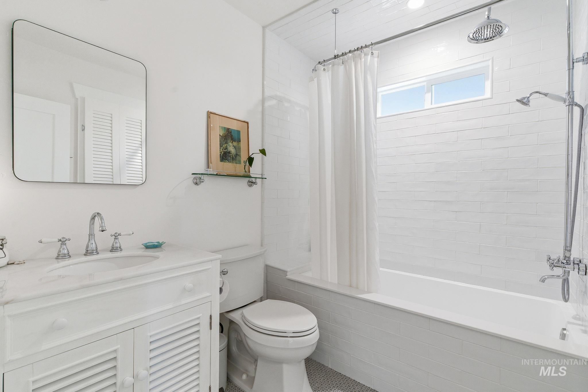 Full bath featuring vanity and tiled shower / bath