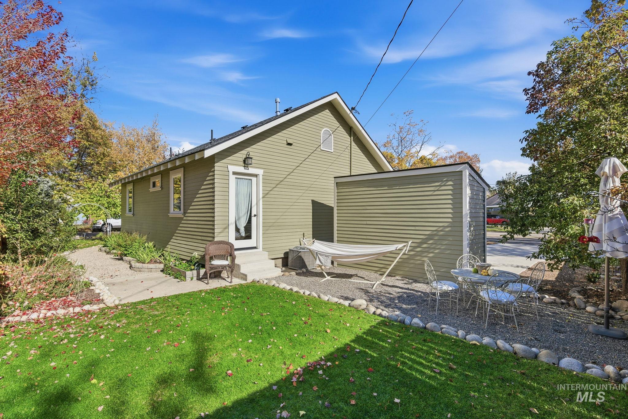 Back of property featuring a yard, entry steps, and a patio
