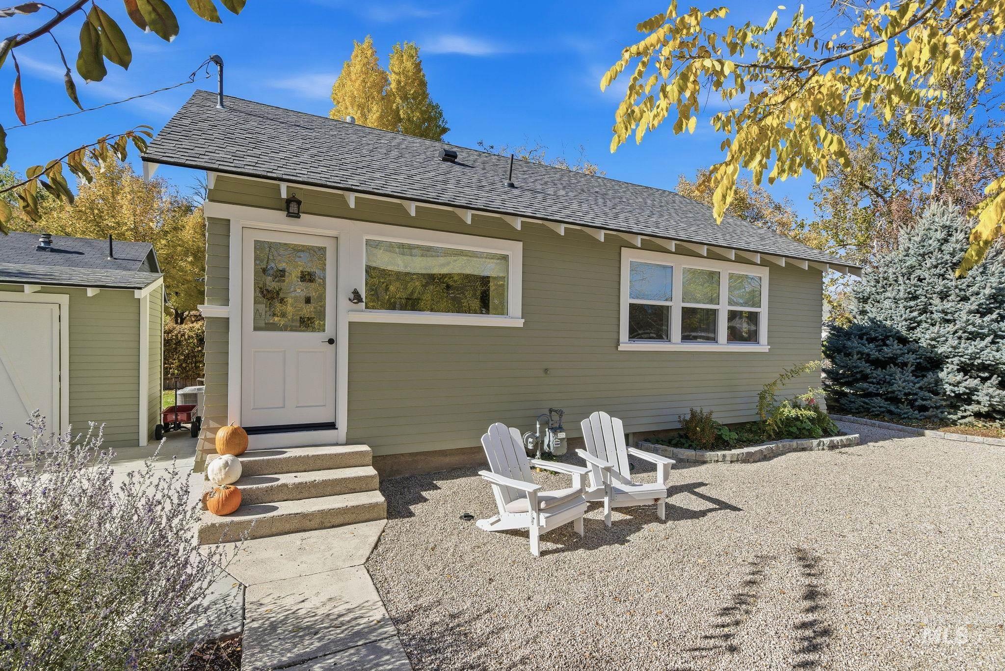 Back of property with a shingled roof and entry steps