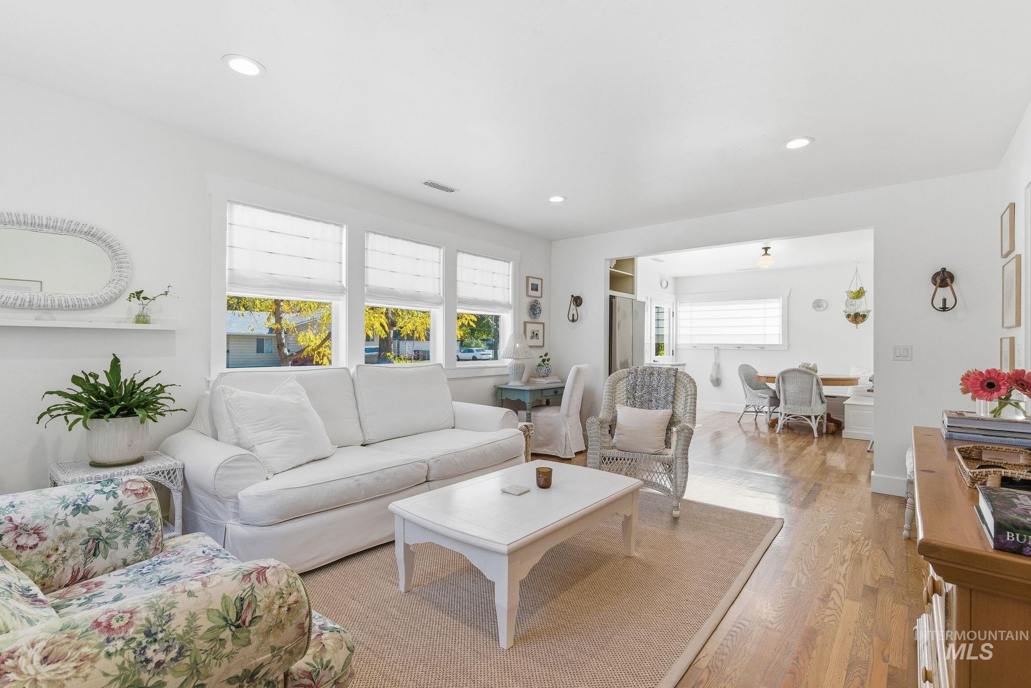 Living room with wood finished floors and recessed lighting