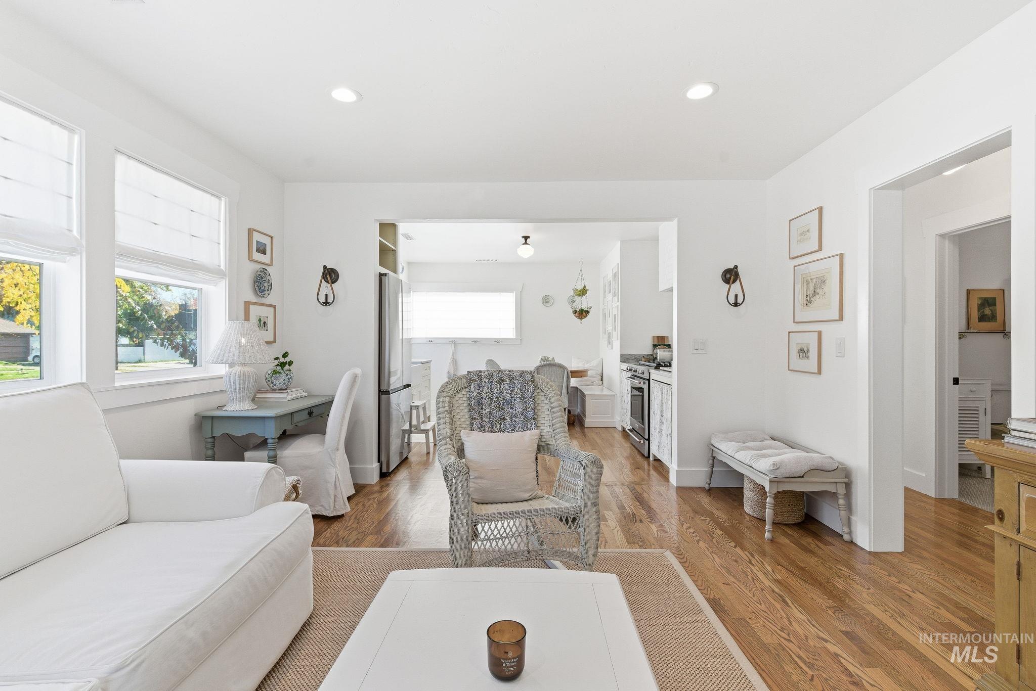 Living room with healthy amount of natural light, recessed lighting, and light wood finished floors
