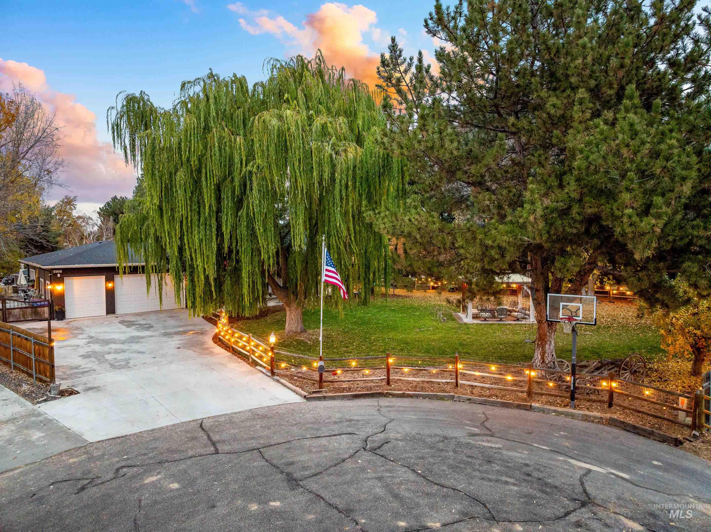 View of front facade with driveway and a garage