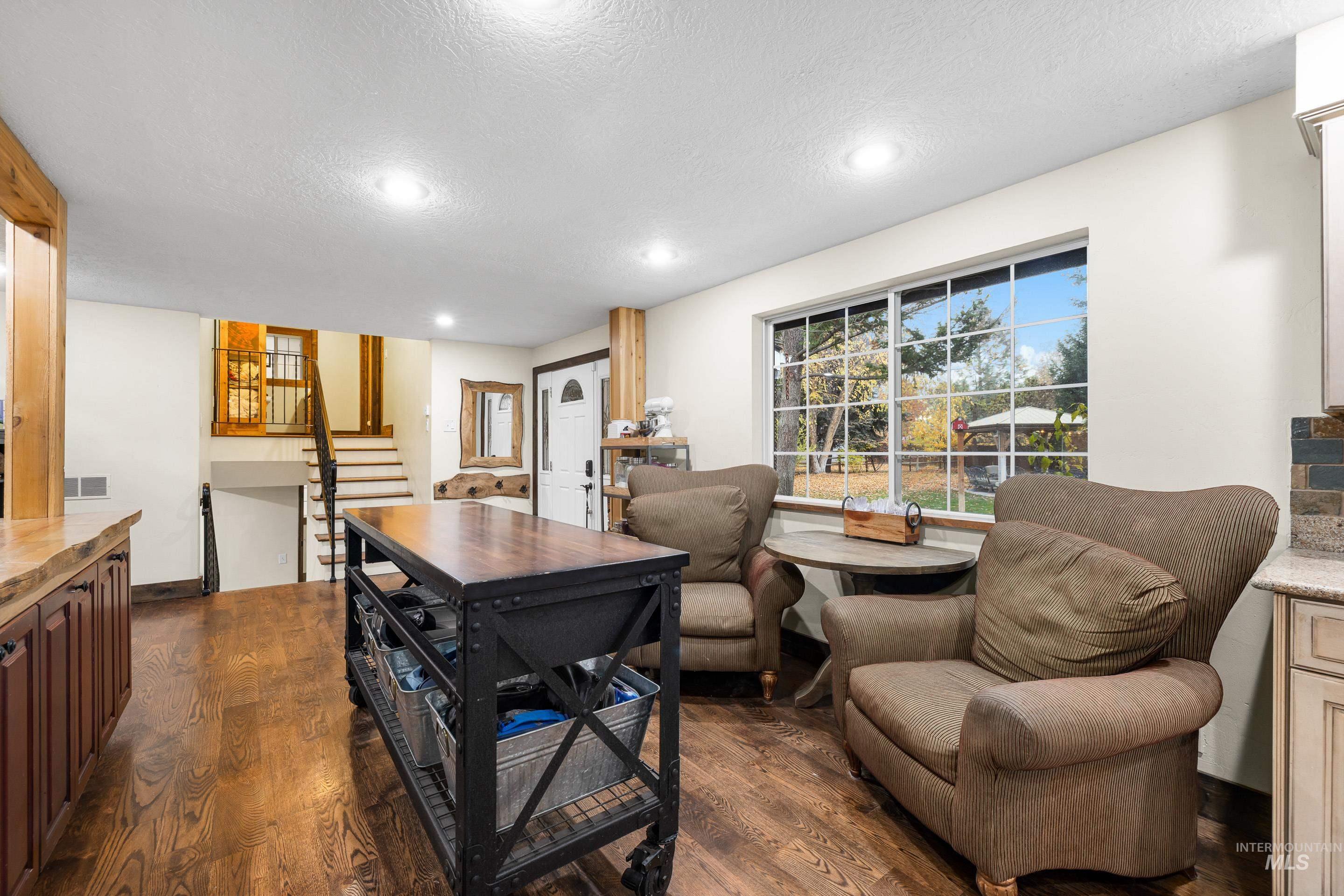 Office area featuring dark wood finished floors, a textured ceiling, and recessed lighting