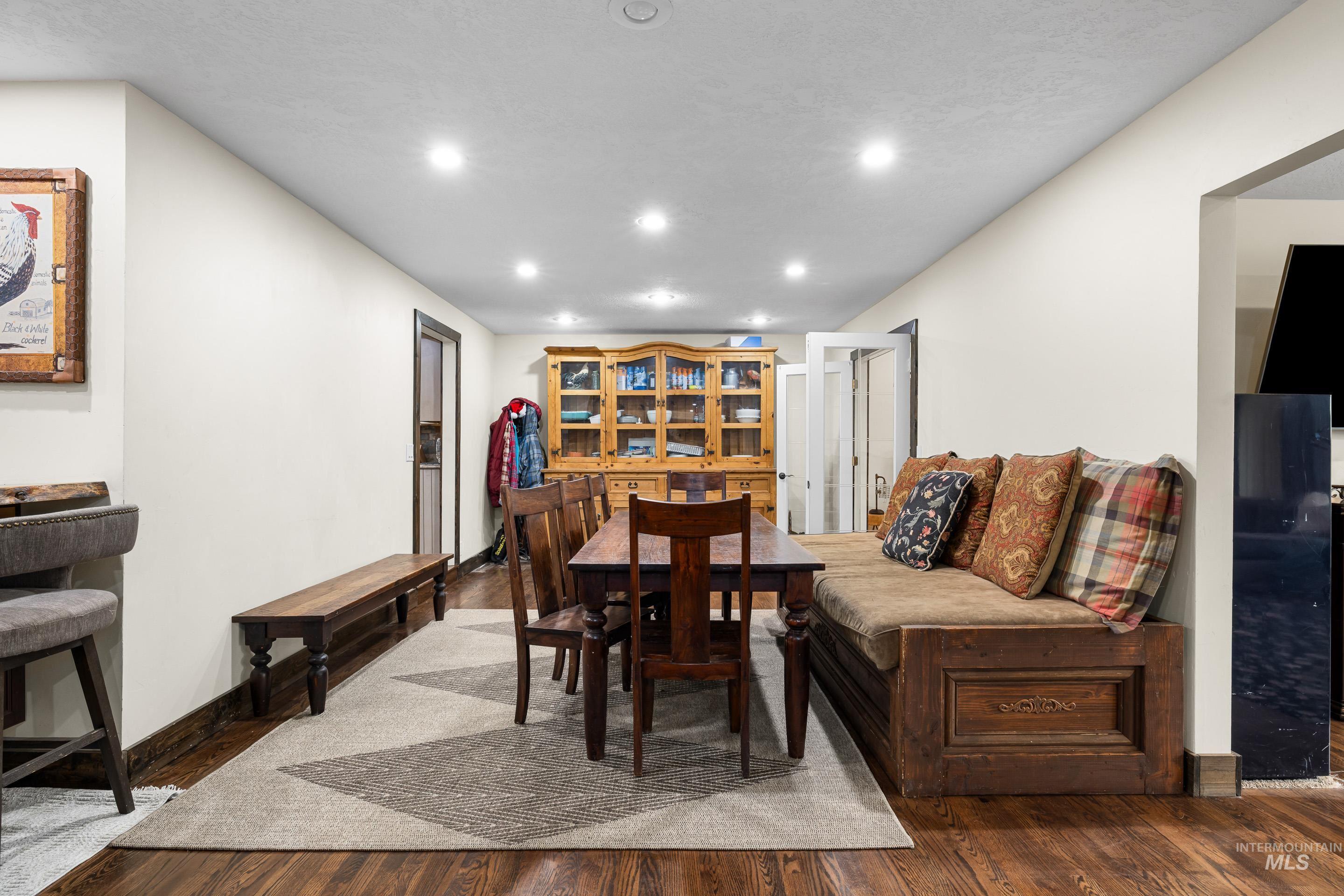 Dining area with recessed lighting and dark wood-type flooring