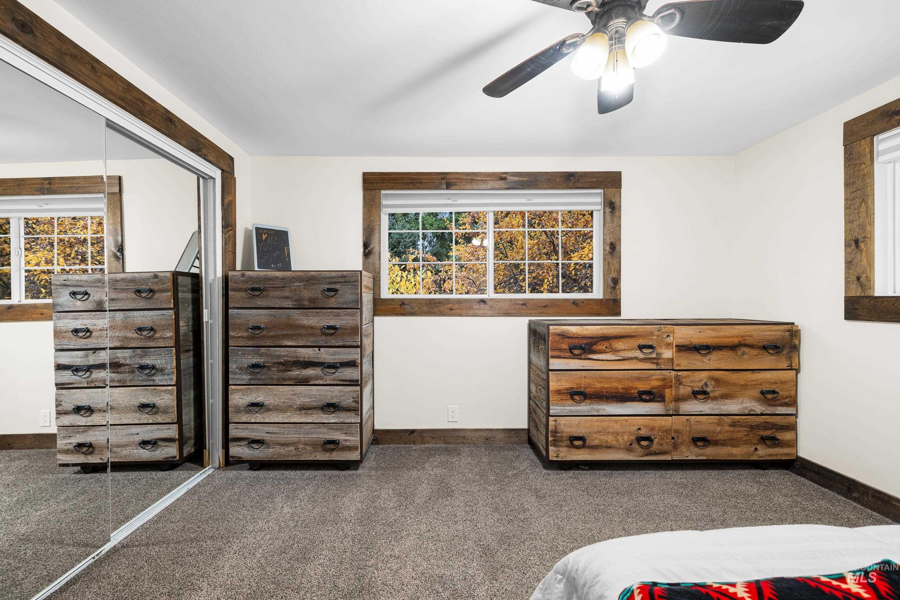 Carpeted bedroom featuring a closet and a ceiling fan