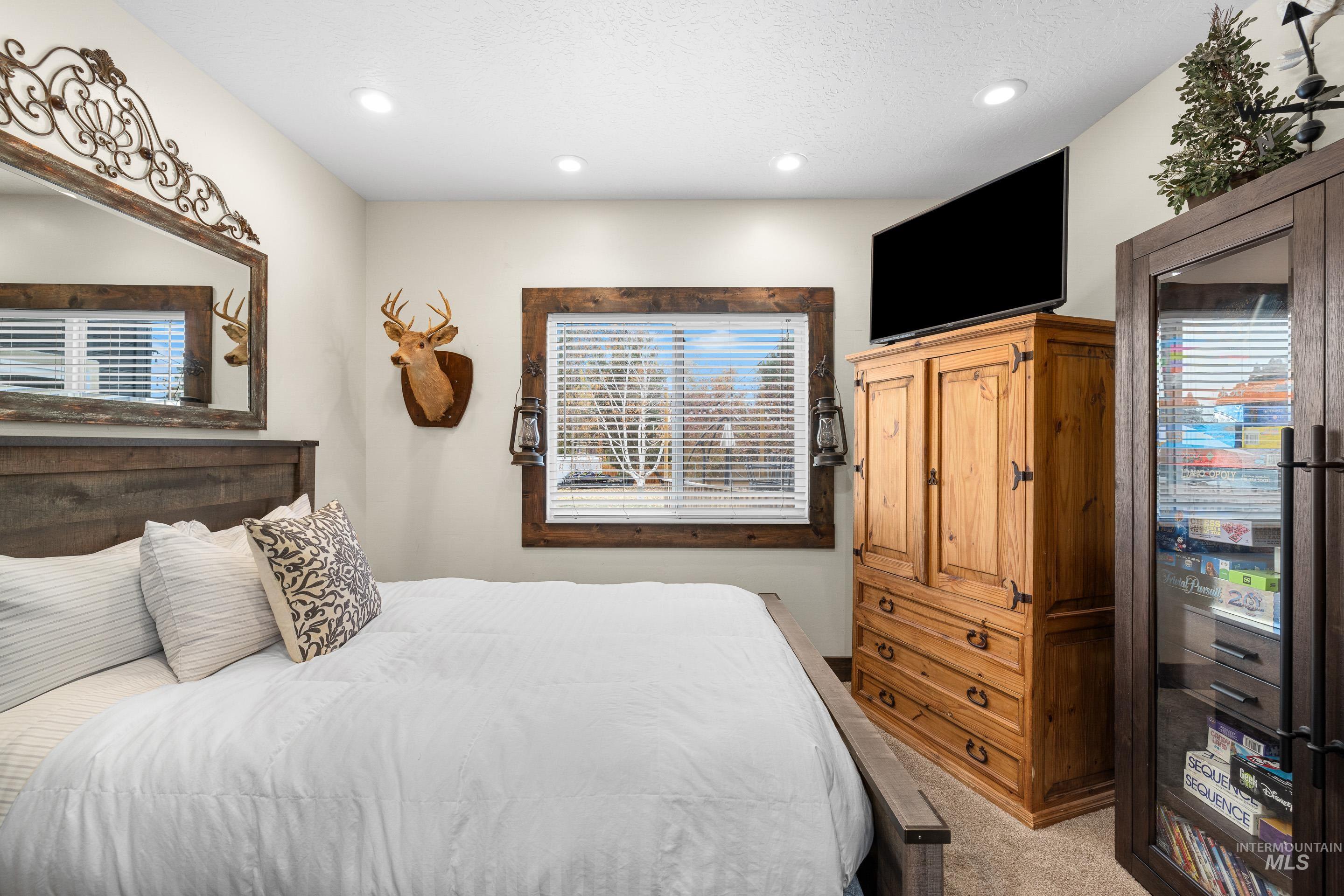 Bedroom with light carpet and recessed lighting