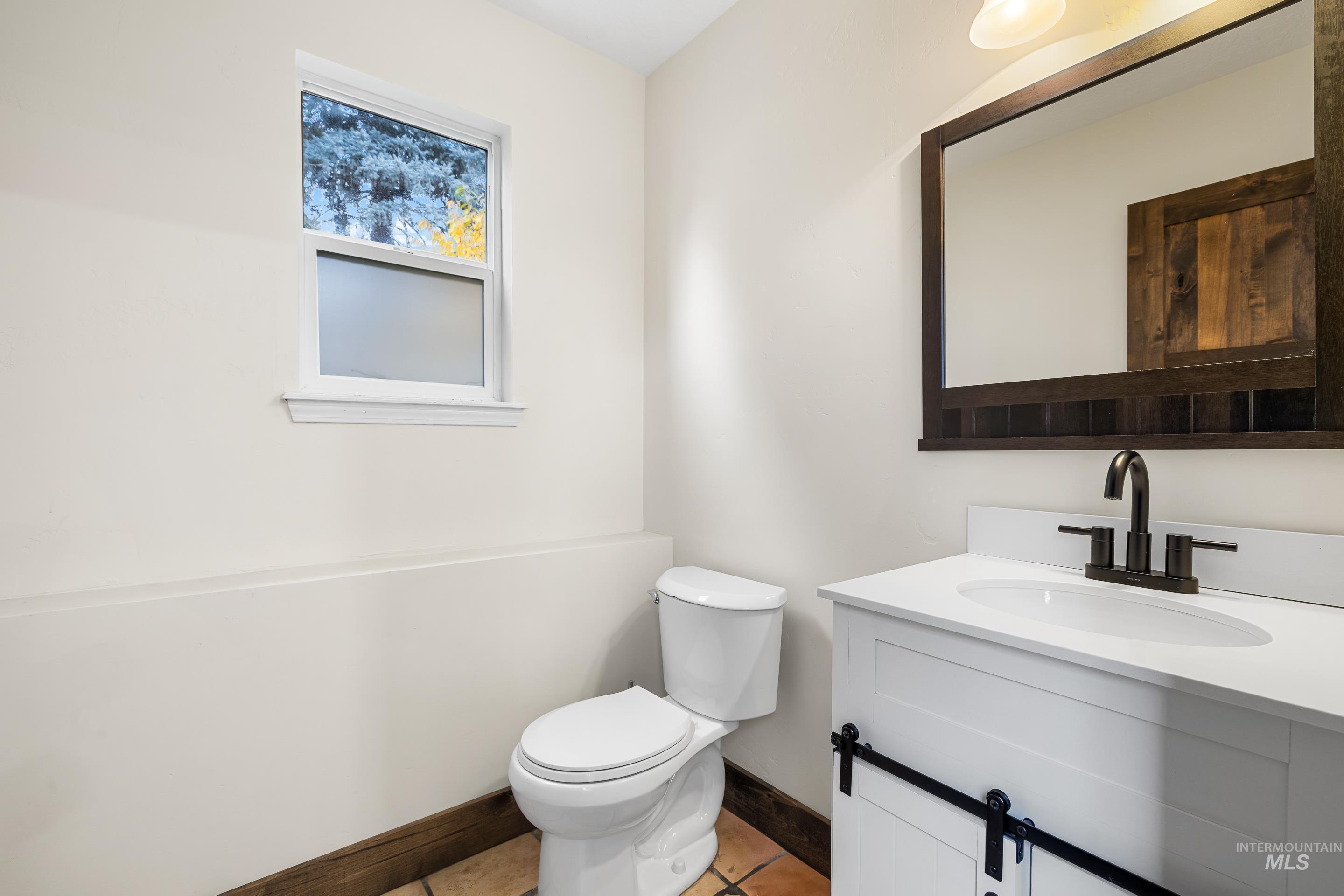 Bathroom with vanity and light tile patterned floors