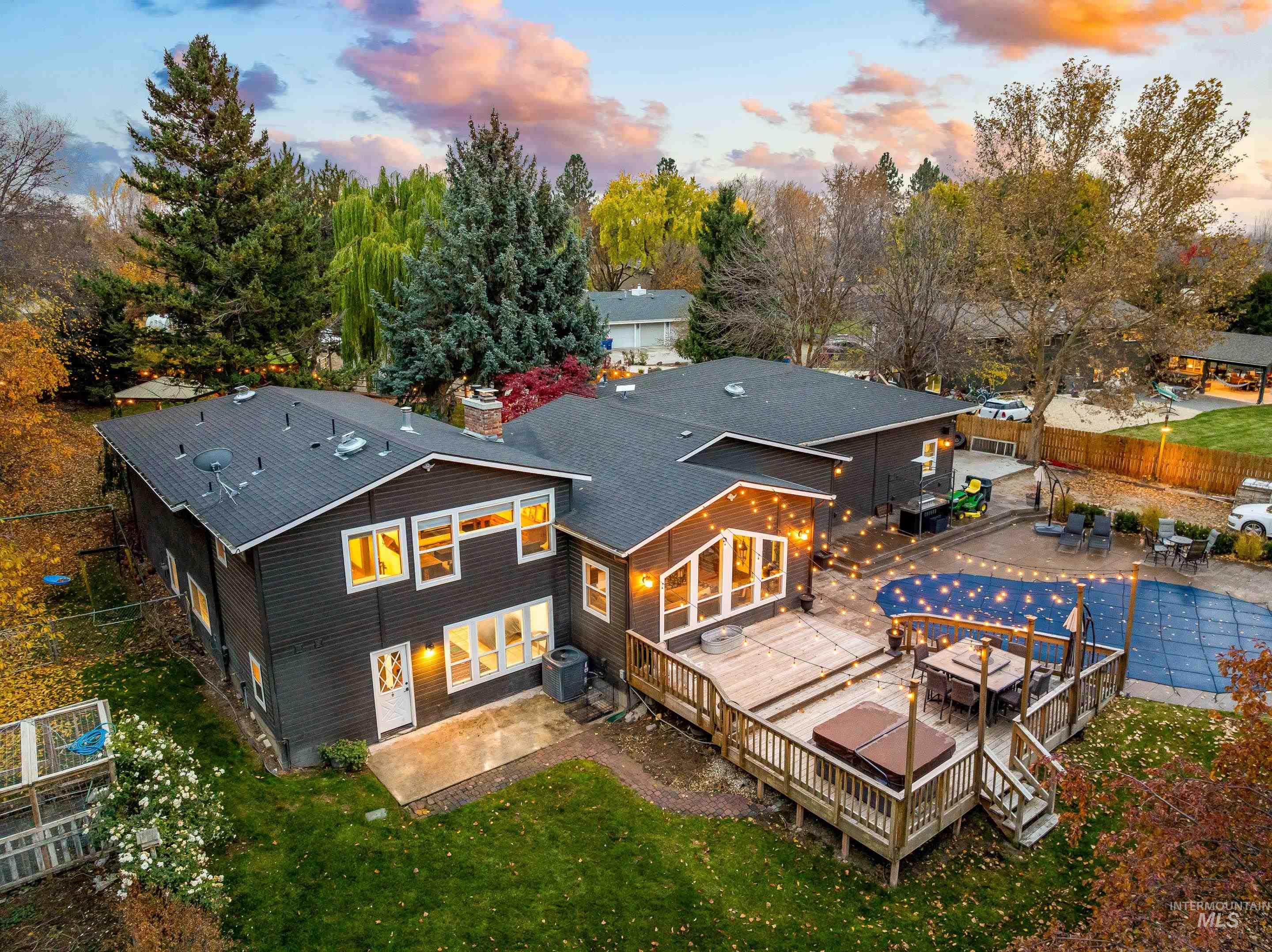 Rear view of property featuring a patio area, a fenced backyard, outdoor dining area, and a chimney