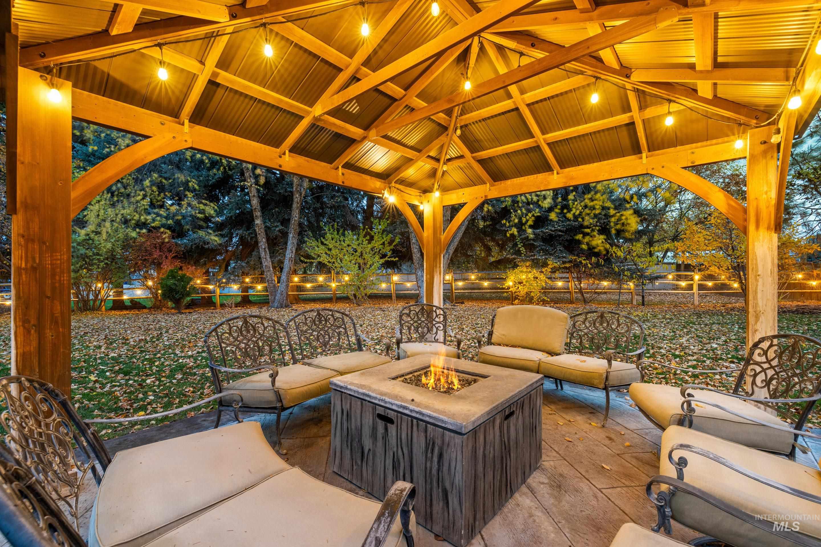 Patio at twilight with an outdoor living space with a fire pit and a patio