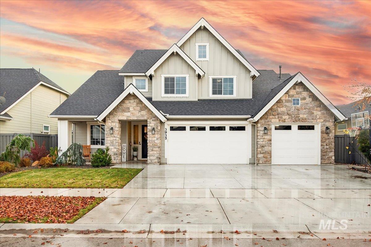Craftsman inspired home with a shingled roof, board and batten siding, concrete driveway, stone siding, and an attached garage