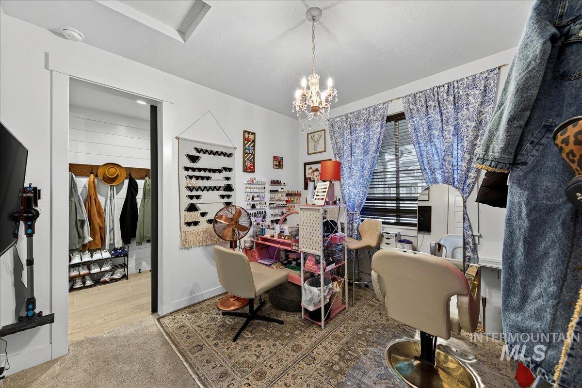 Dining room with a chandelier, carpet, and a desk