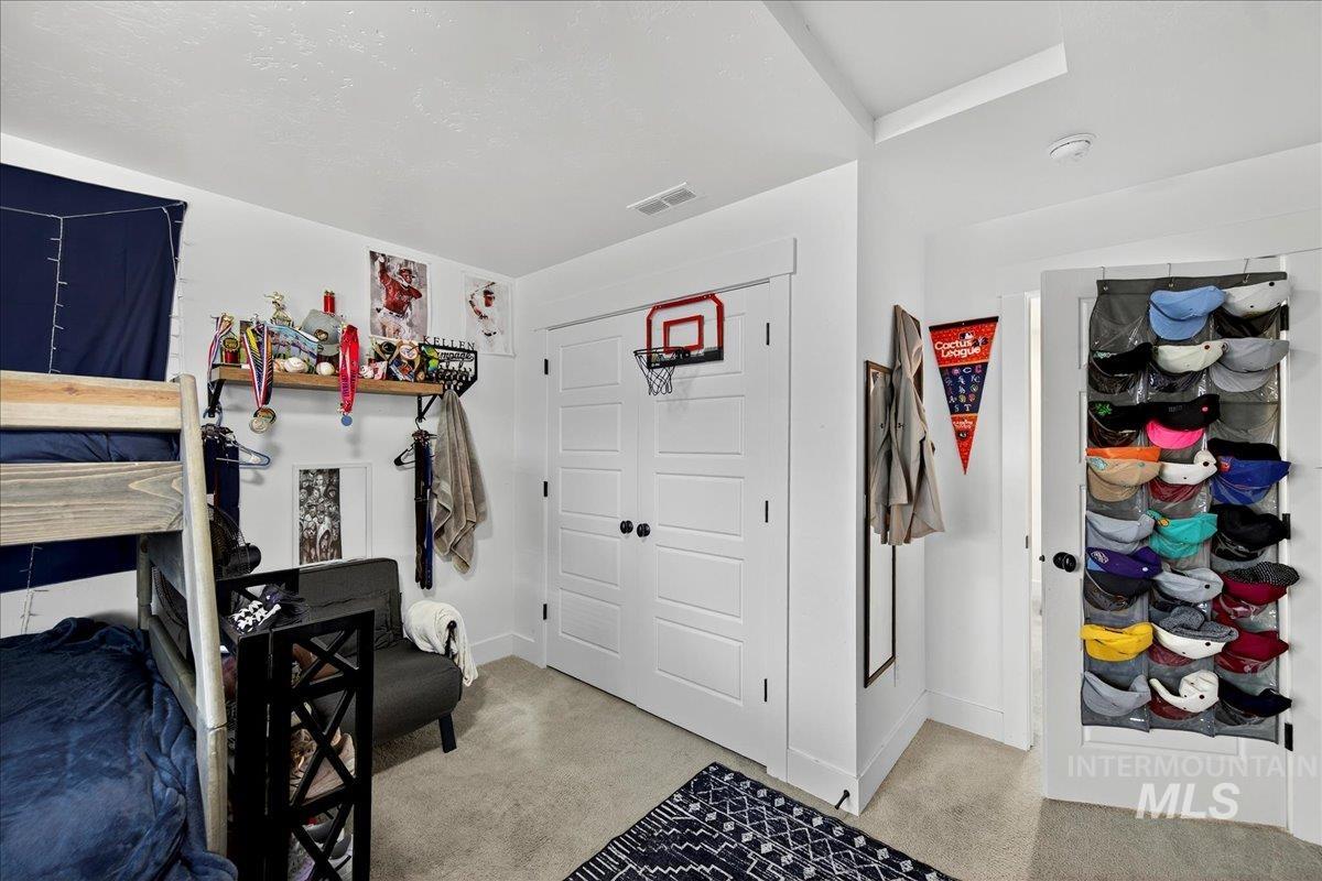Bedroom featuring a closet and light colored carpet