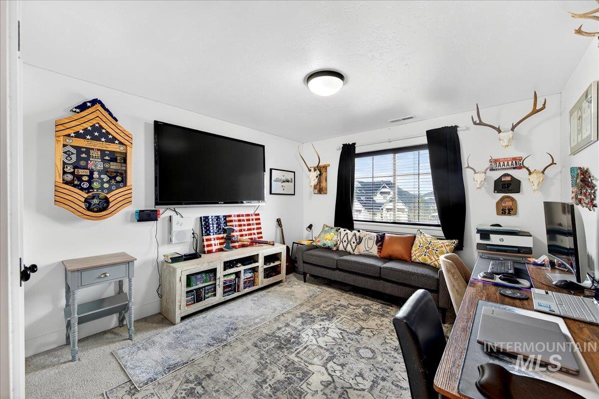 Bedroom with a desk and carpet flooring