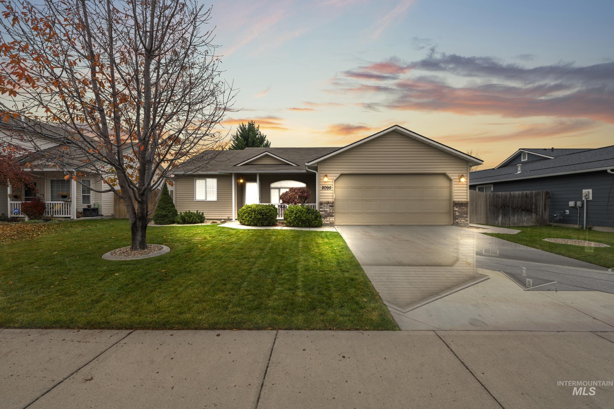 Ranch-style house with concrete driveway, an attached garage, and brick siding