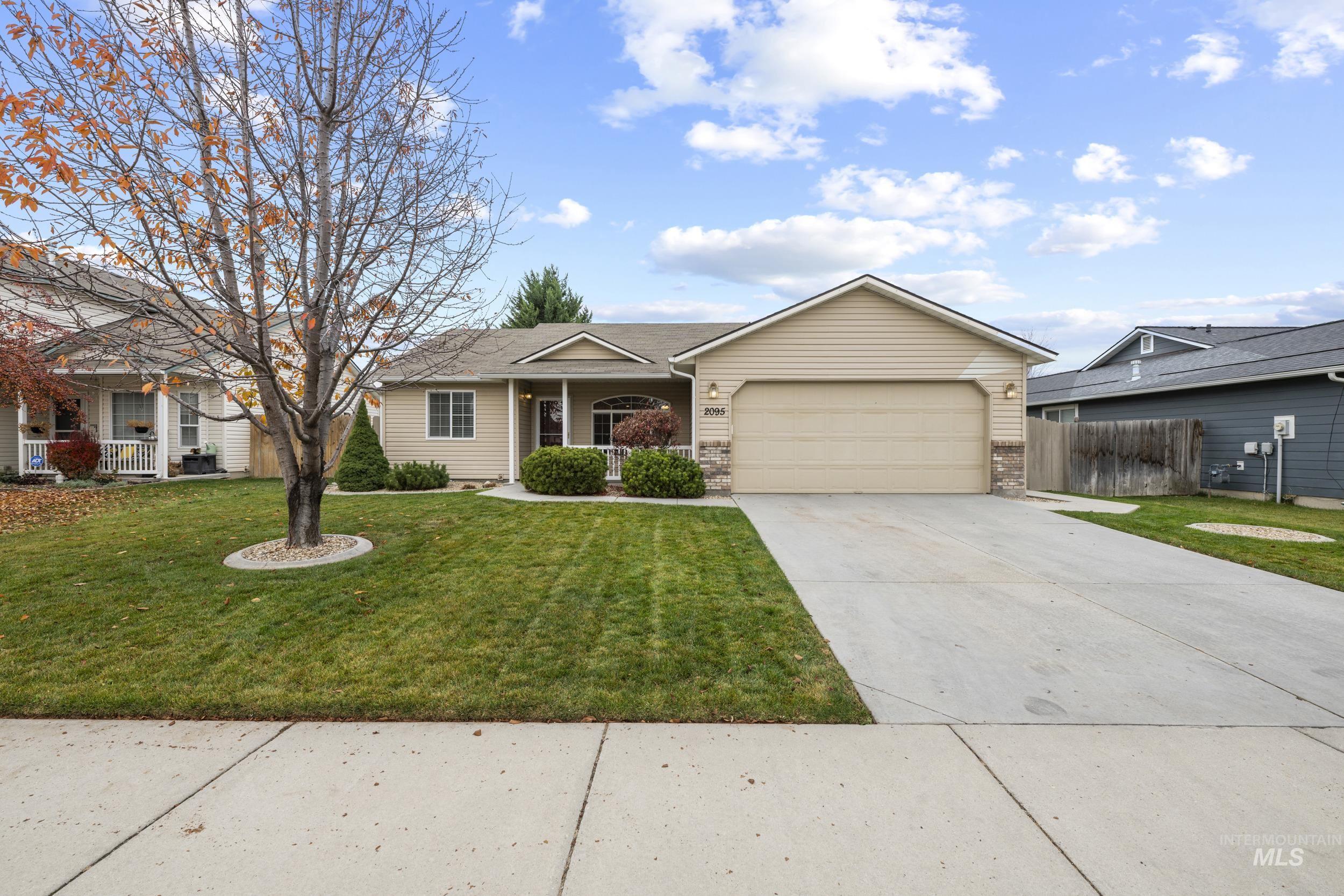 Ranch-style house featuring concrete driveway, a porch, and a garage