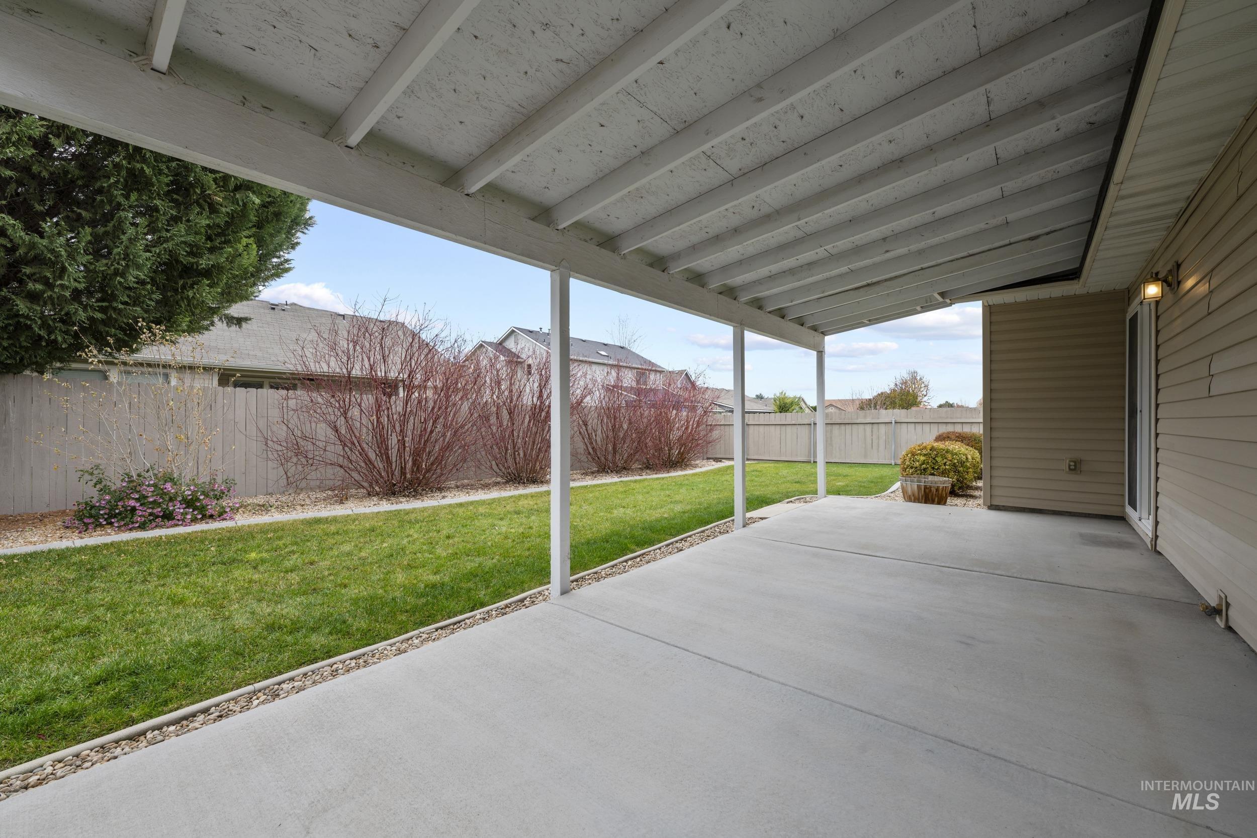 Fenced backyard with a patio area