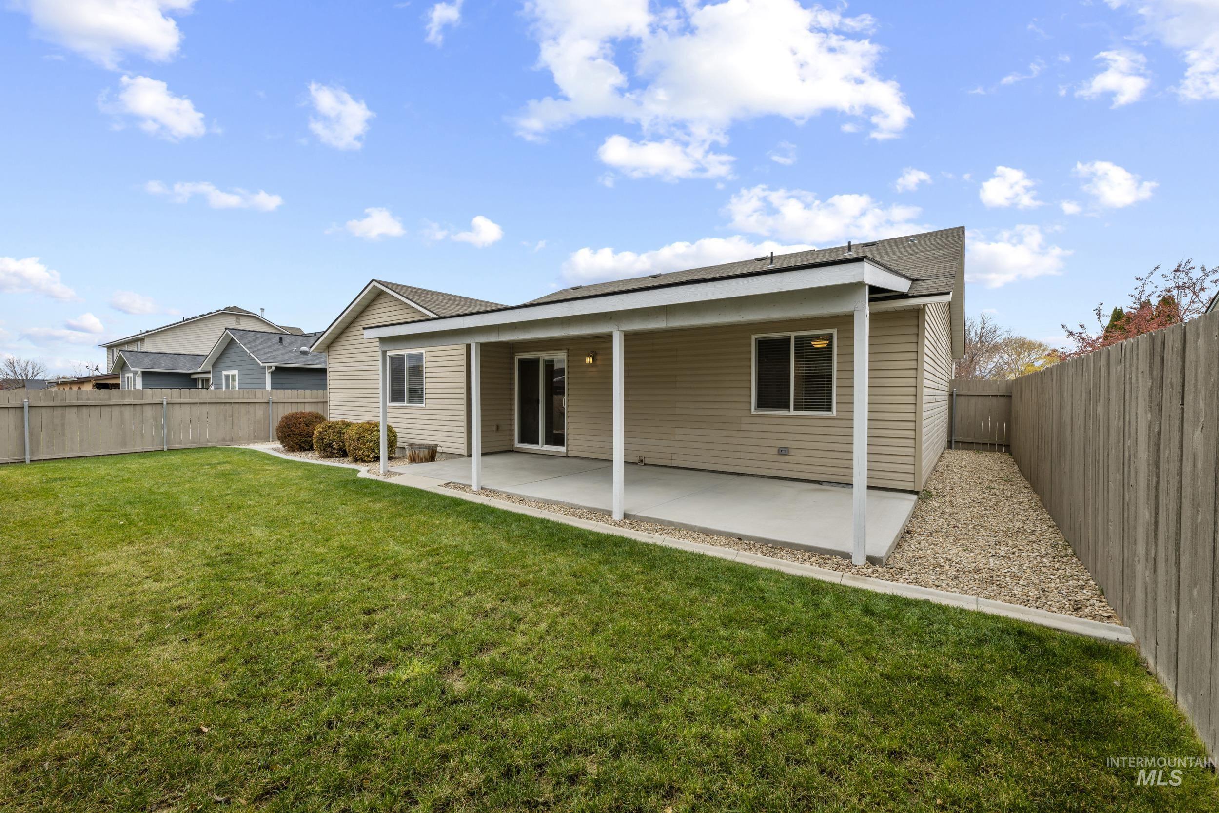 Back of house with a patio and a fenced backyard