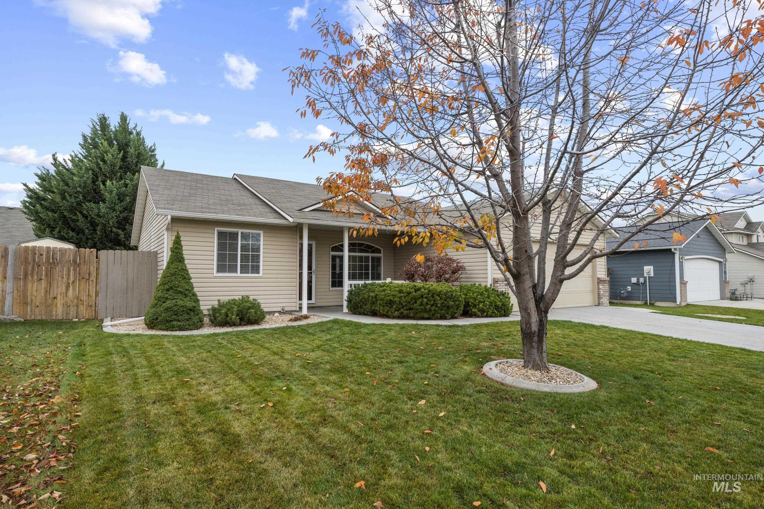 Ranch-style home featuring driveway, covered porch, a shingled roof, and an attached garage