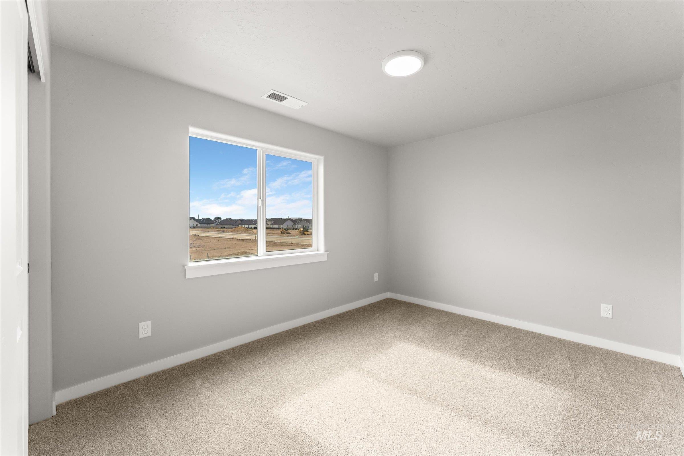 Empty room with carpet flooring and baseboards