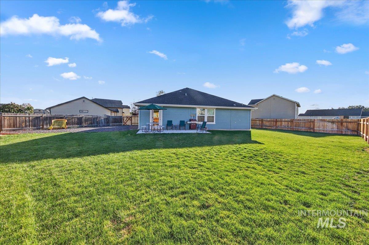 Back of property with a fenced backyard and a patio