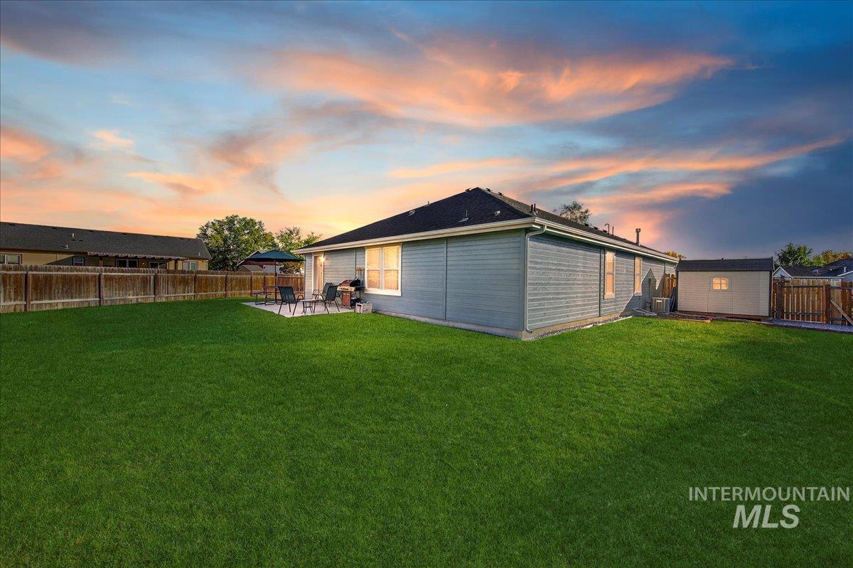 Rear view of house with a patio area and a fenced backyard