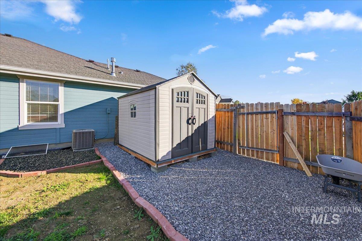View of shed featuring a gate