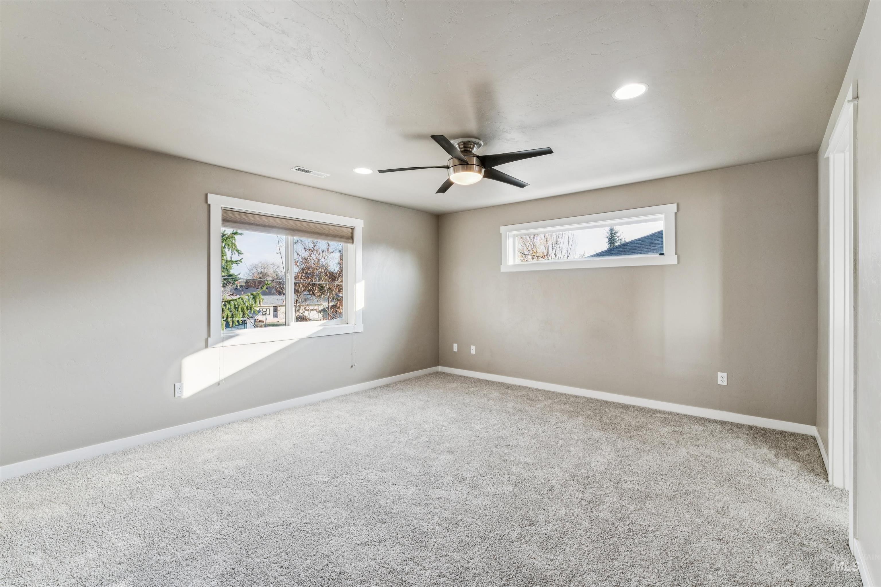 Spare room with carpet flooring, ceiling fan, and recessed lighting