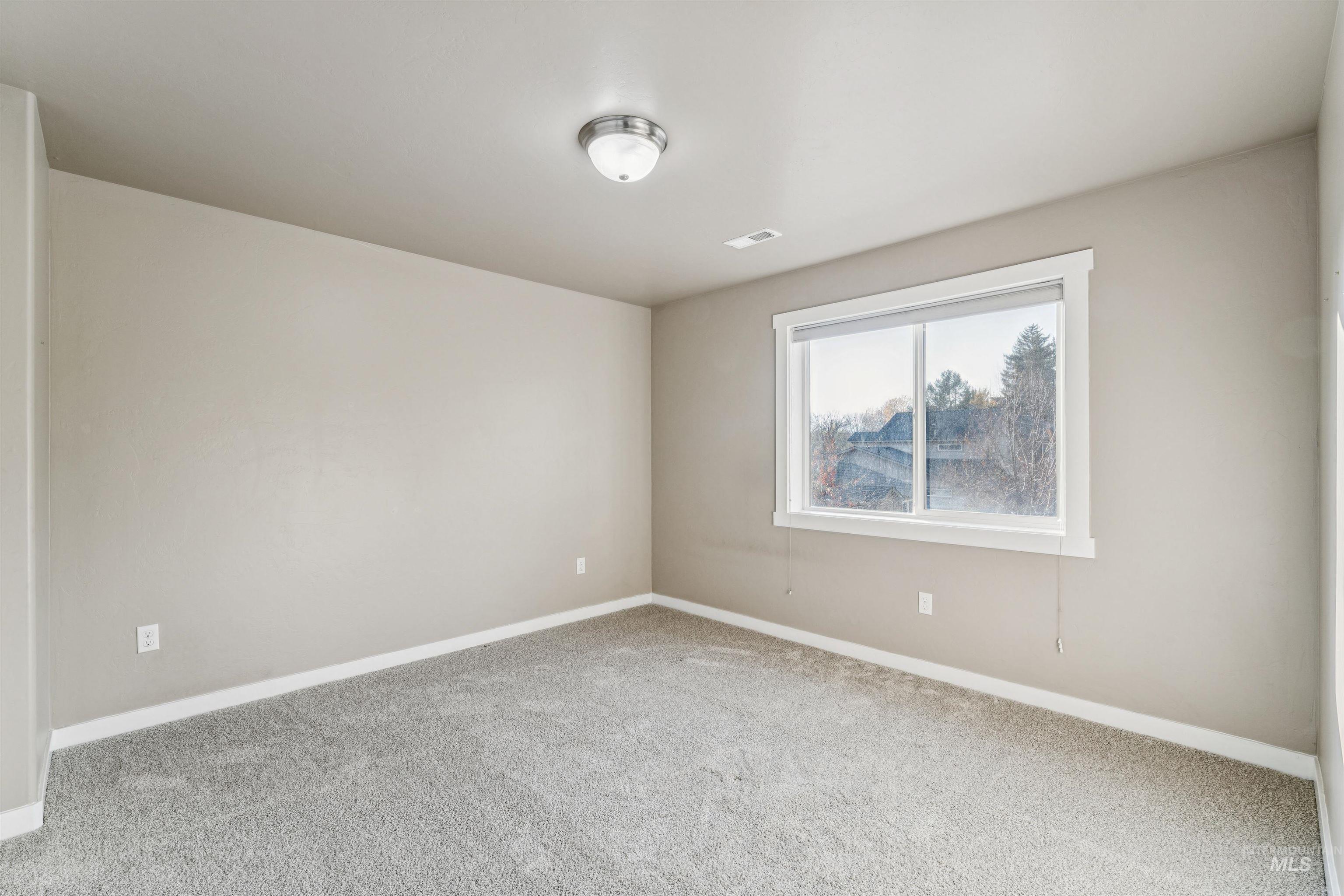 Unfurnished room featuring carpet flooring