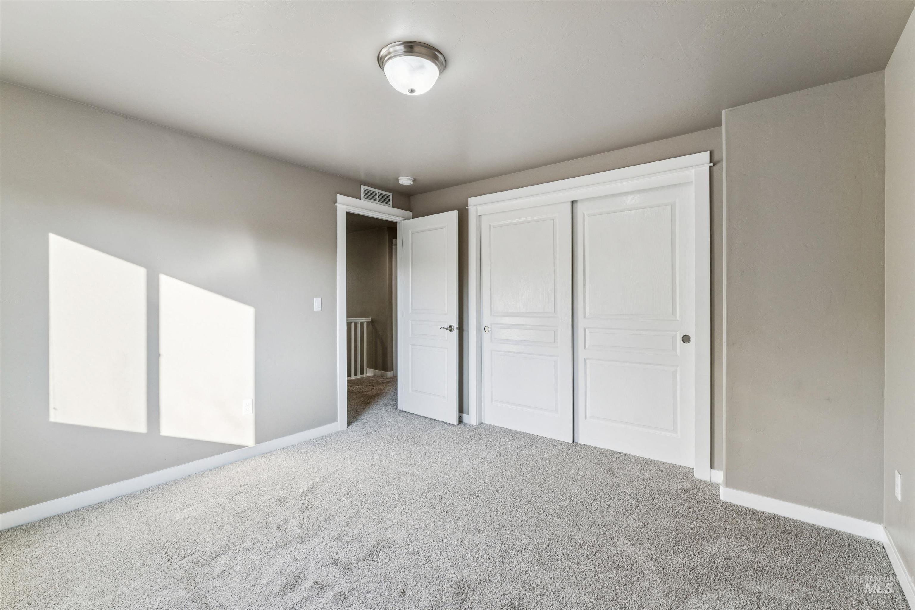 Unfurnished bedroom with a closet and carpet floors