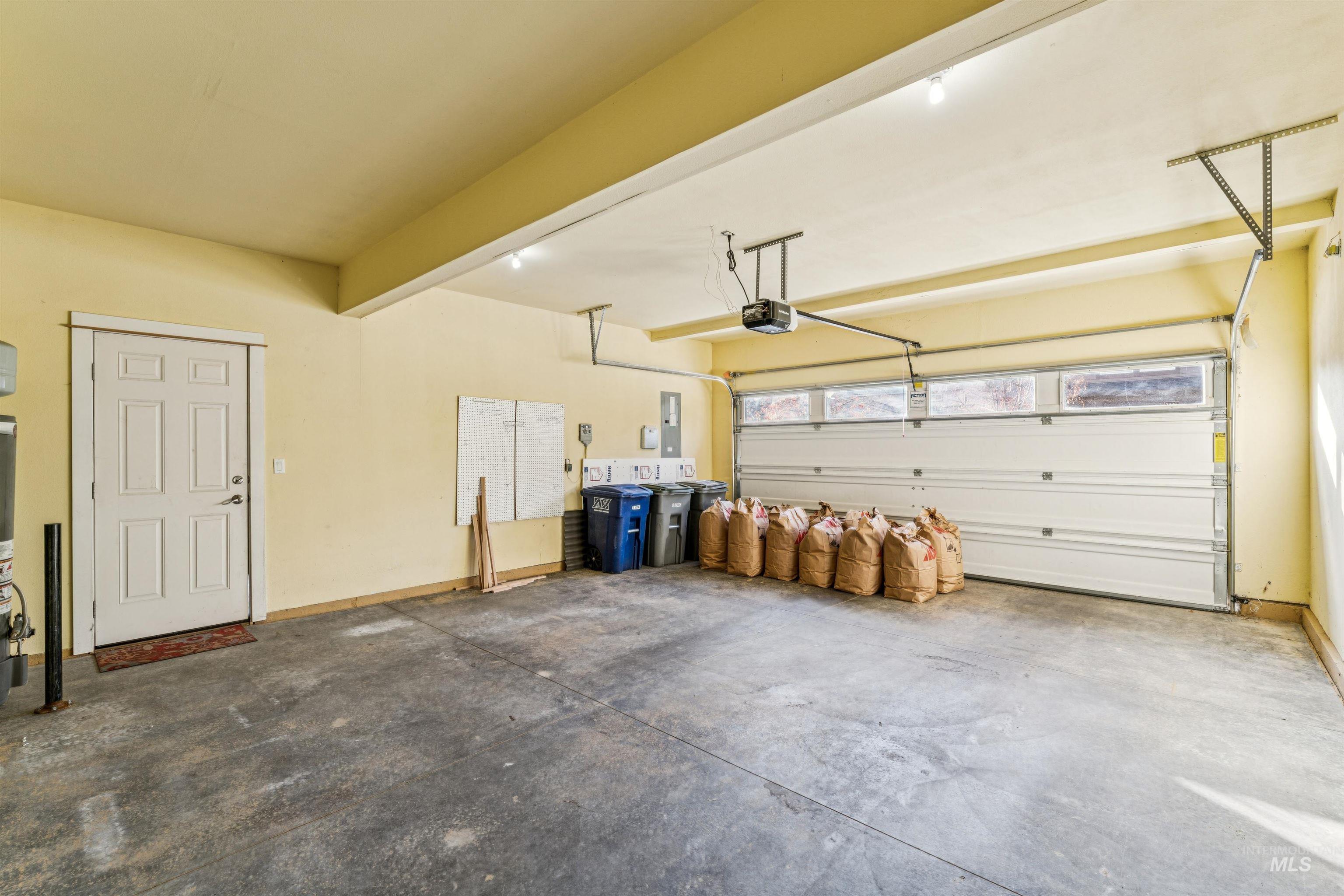 Garage with electric panel and a garage door opener